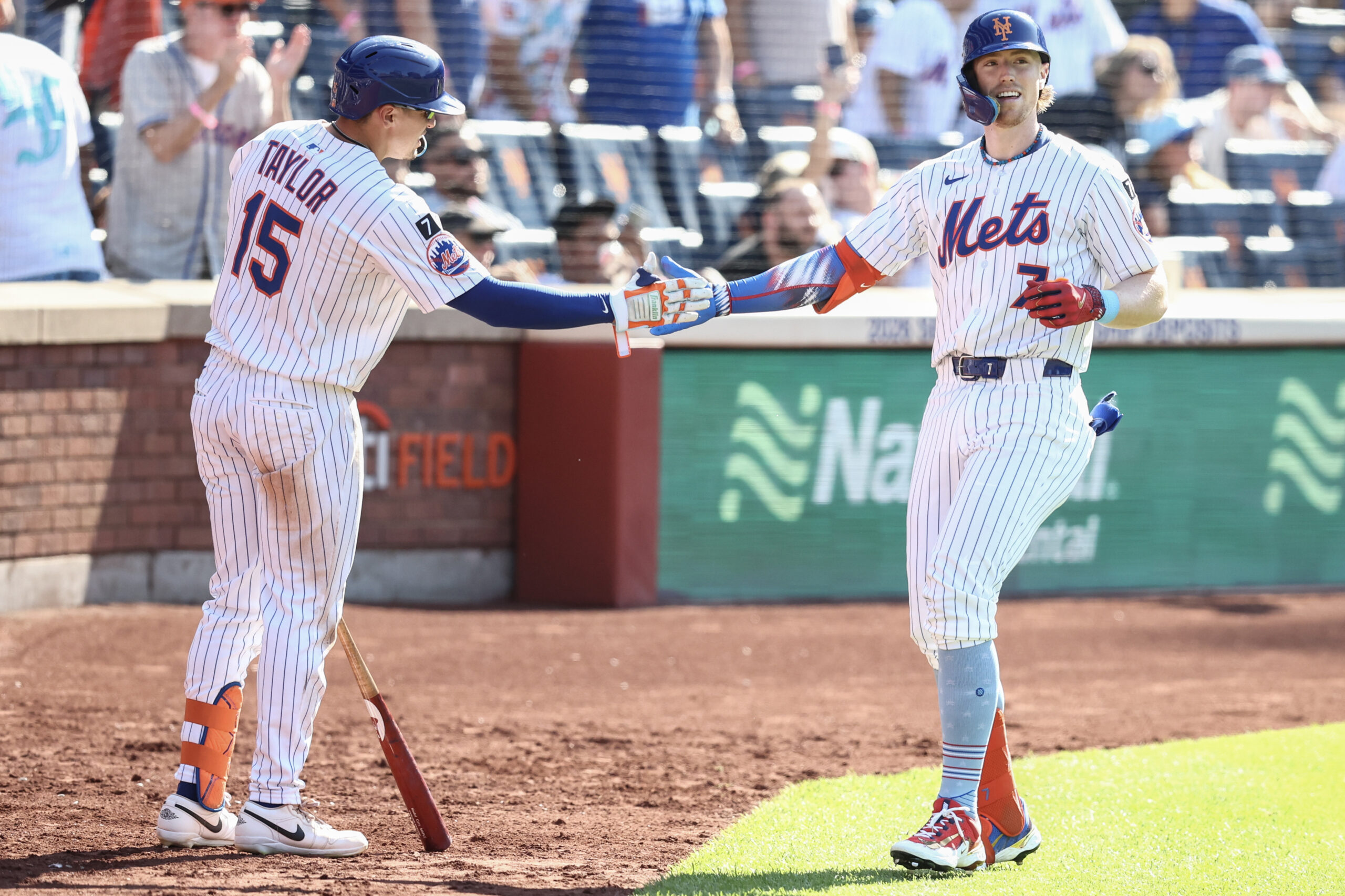 Jul 4, 2025; New York City, New York, USA;  New York Mets third baseman Brett Baty (7) is greeted by center fielder Tyrone Taylor (15) after hitting a solo home run in the sixth inning against the New York Yankees at Citi Field. Mandatory Credit: Wendell Cruz-Imagn Images