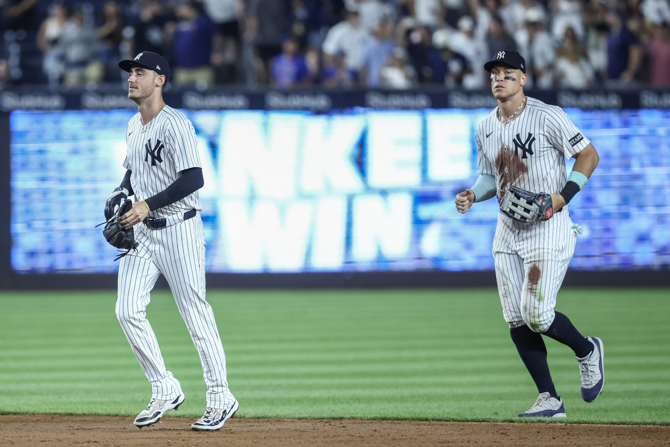 Jul 11, 2025; Bronx, New York, USA;  New York Yankees center fielder Cody Bellinger (35) and right fielder Aaron Judge (99) walk off the field after defeating the Chicago Cubs 11-0 at Yankee Stadium. Mandatory Credit: Wendell Cruz-Imagn Images