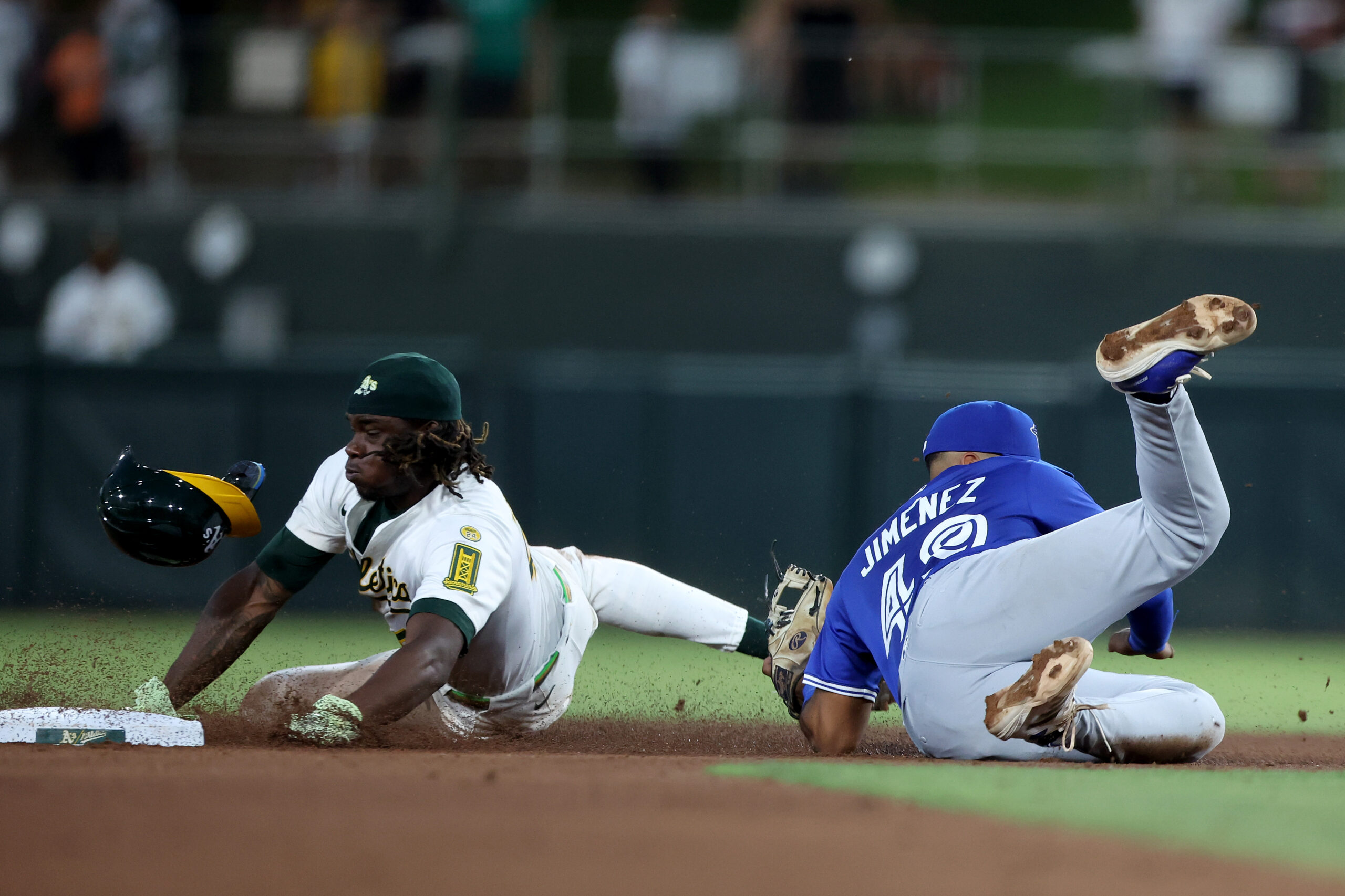 Jul 12, 2025; West Sacramento, California, USA; Athletics right fielder Lawrence Butler (4) is tagged out by Toronto Blue Jays second baseman Leo Jimenez (49) on a steal attempt during the fifth inning  at Sutter Health Park. Mandatory Credit: Dennis Lee-Imagn Images