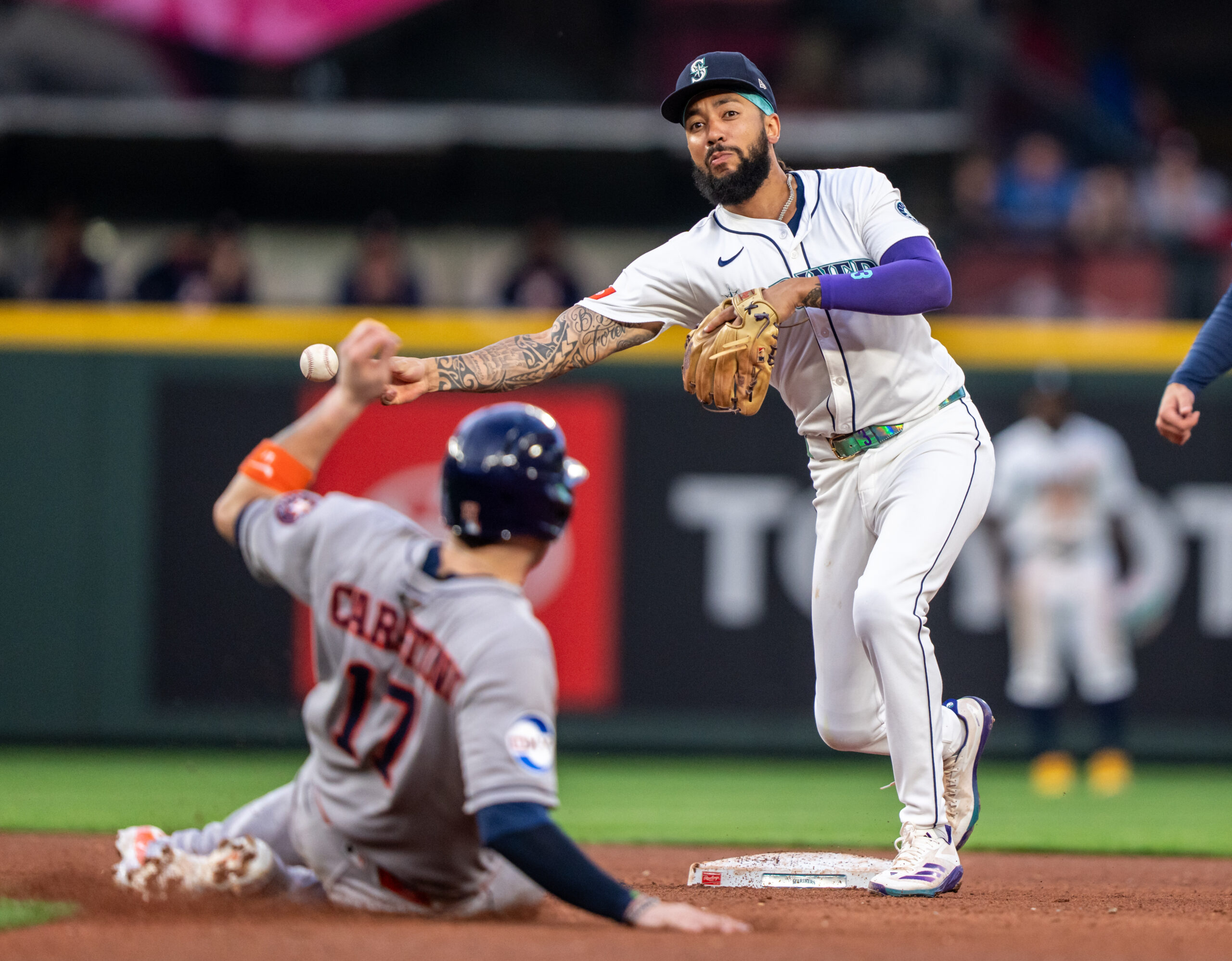 Jul 19, 2025; Seattle, Washington, USA;  Seattle Mariners shortstop J.P. Crawford (3) turns a double play after forcing out Houston Astros right fielder Cam Smith (11) at second base during the fifth inning at T-Mobile Park. Mandatory Credit: Stephen Brashear-Imagn Images