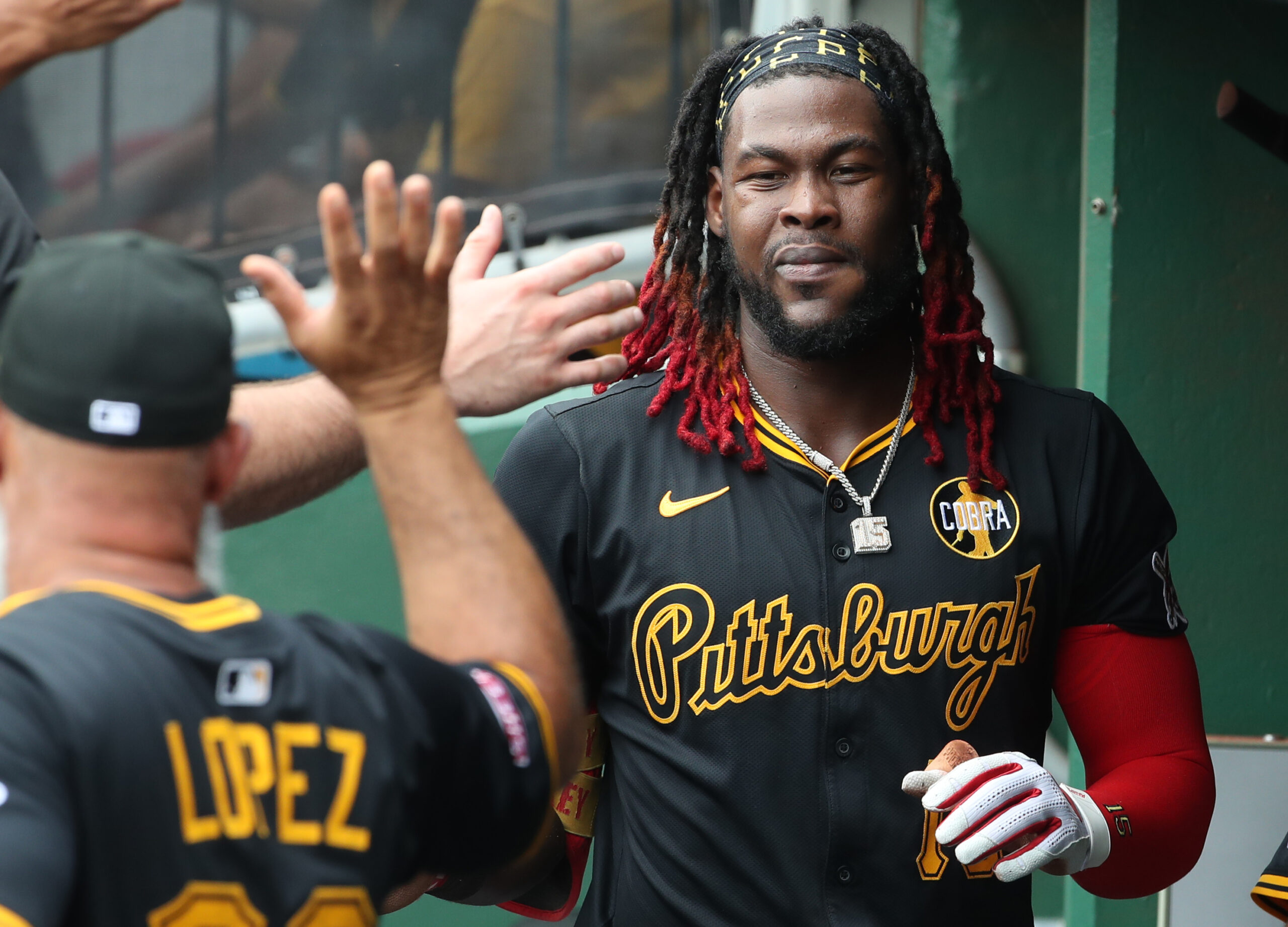 Jul 27, 2025; Pittsburgh, Pennsylvania, USA; Pittsburgh Pirates center fielder Oneil Cruz (15) celebrates in the dugout after scoring a run against the Arizona Diamondbacks during the second inning at PNC Park. Mandatory Credit: Charles LeClaire-Imagn Images