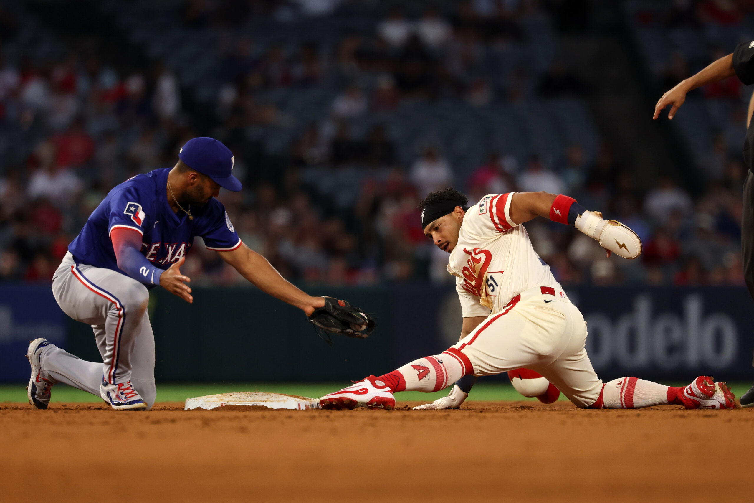 Jul 29, 2025; Anaheim, California, USA; Los Angeles Angels right fielder Gustavo Campero (51) is tagged out by Texas Rangers second baseman Marcus Semien (2) as he tries to steal second during the fourth inning at Angel Stadium. Mandatory Credit: Kiyoshi Mio-Imagn Images