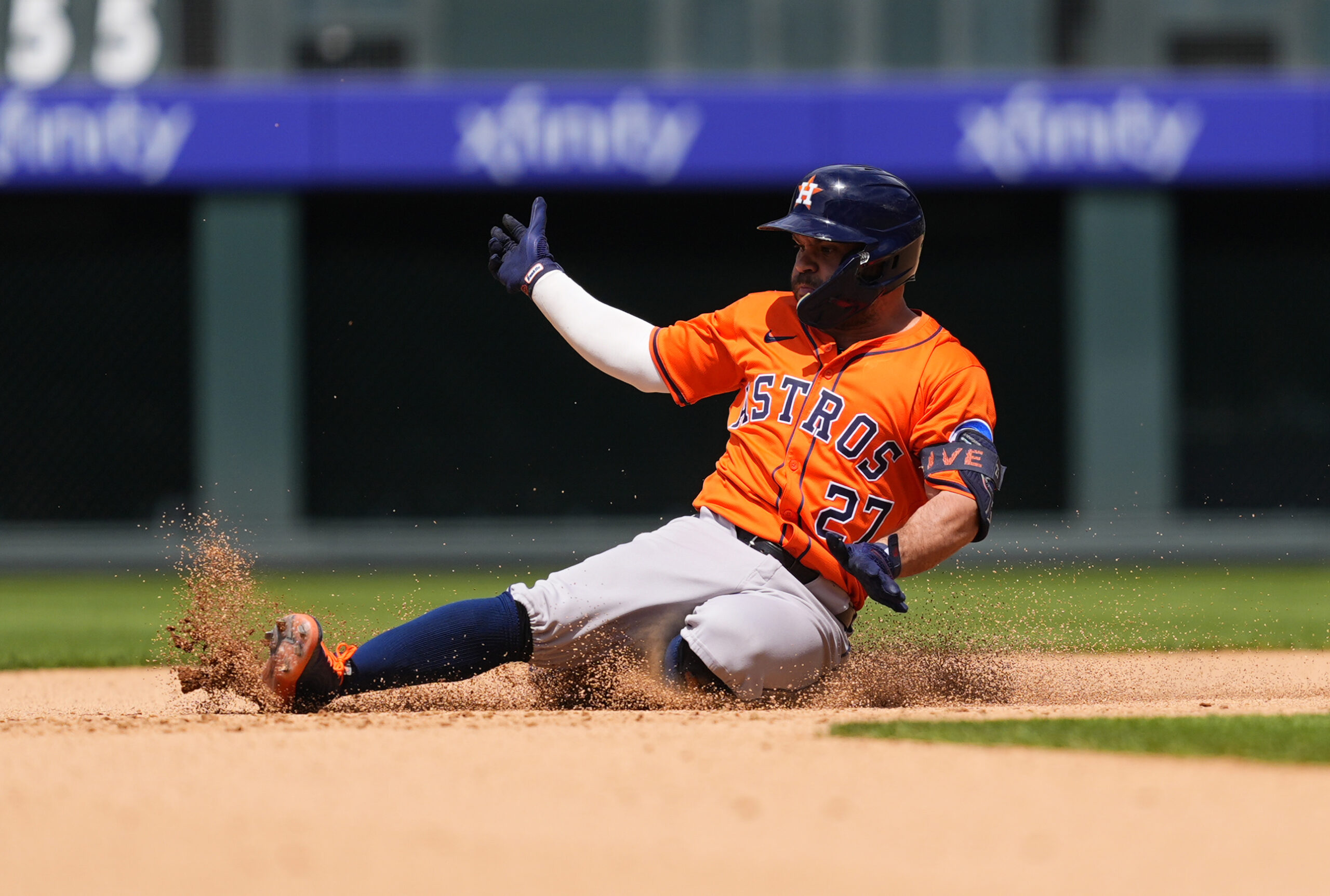 Jul 3, 2025; Denver, Colorado, USA; Houston Astros designated hitter Jose Altuve (27) slides for a double in the seventh inning against the Colorado Rockies at Coors Field. Mandatory Credit: Ron Chenoy-Imagn Images