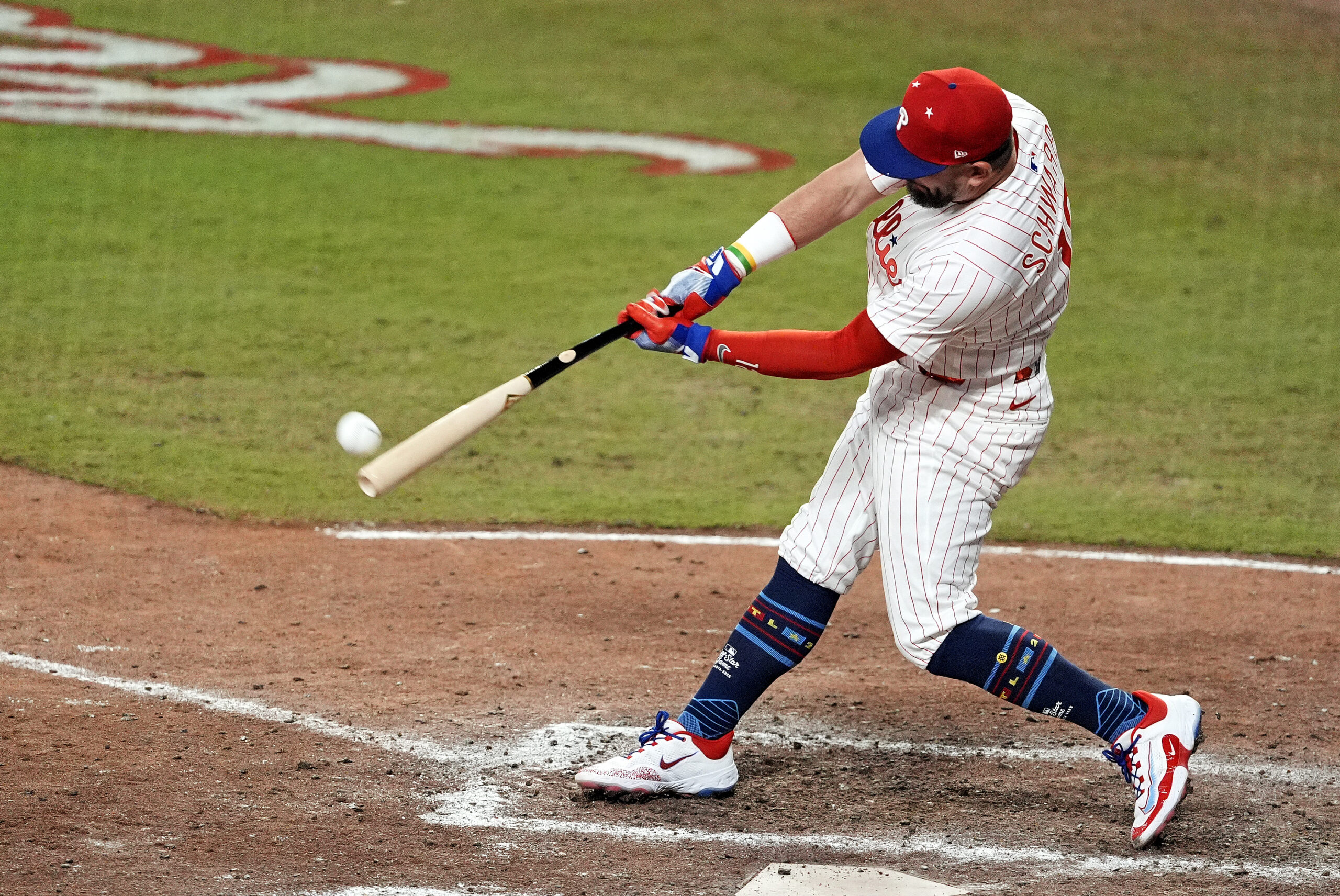 Jul 15, 2025; Cumberland, Georgia, USA; National League designated hitter Kyle Schwarber (12) of the Philadelphia Phillies hits a home run in the swing off of after the  2025 MLB All Star Game ended in a tie at Truist Park. Mandatory Credit: Dale Zanine-Imagn Images