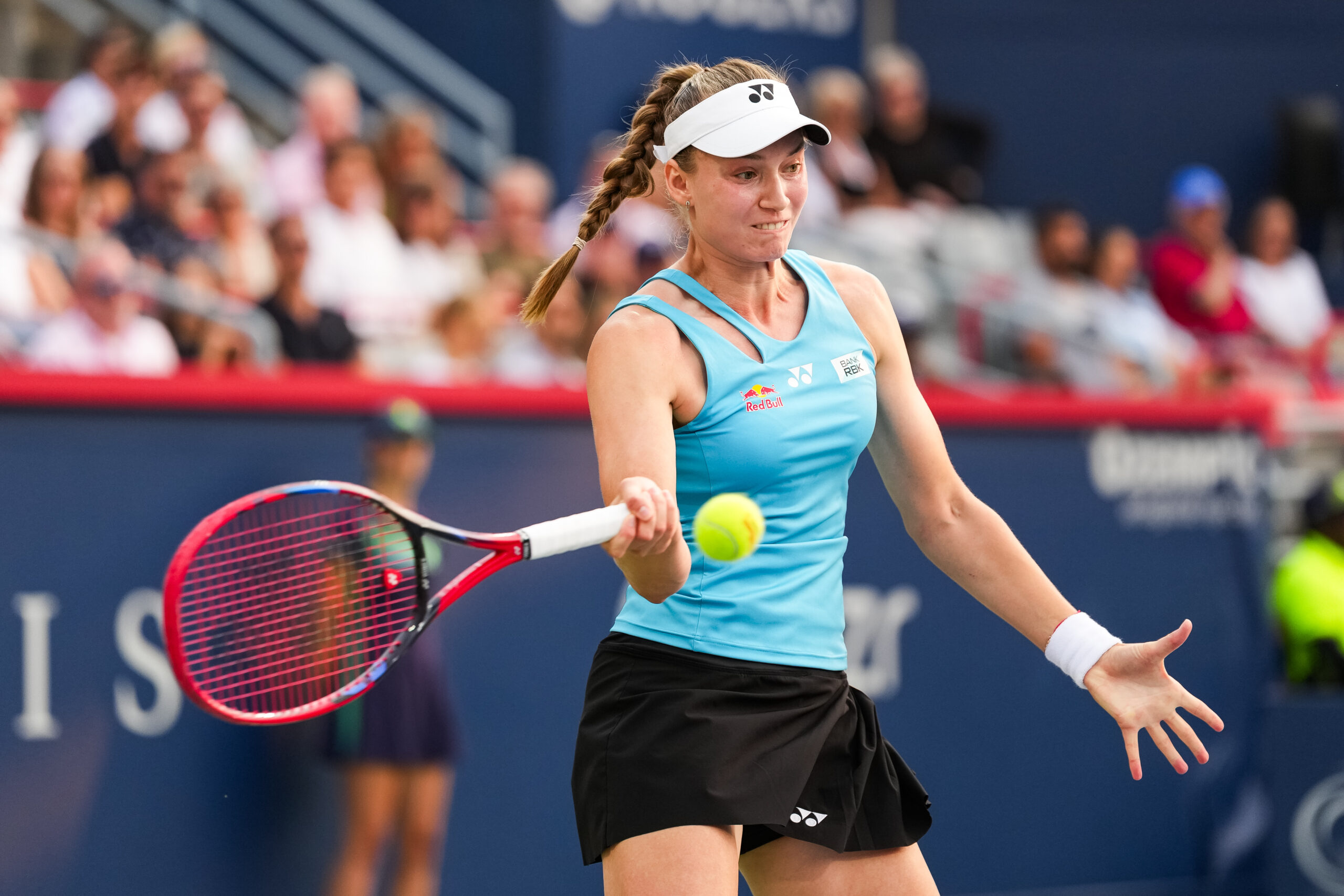 Aug 4, 2025; Montreal, QC, Canada; Elena Rybakina (KAZ) returns the ball to Marta Kostyuk (UKR) in quarterfinal play at IGA Stadium. Mandatory Credit: David Kirouac-Imagn Images