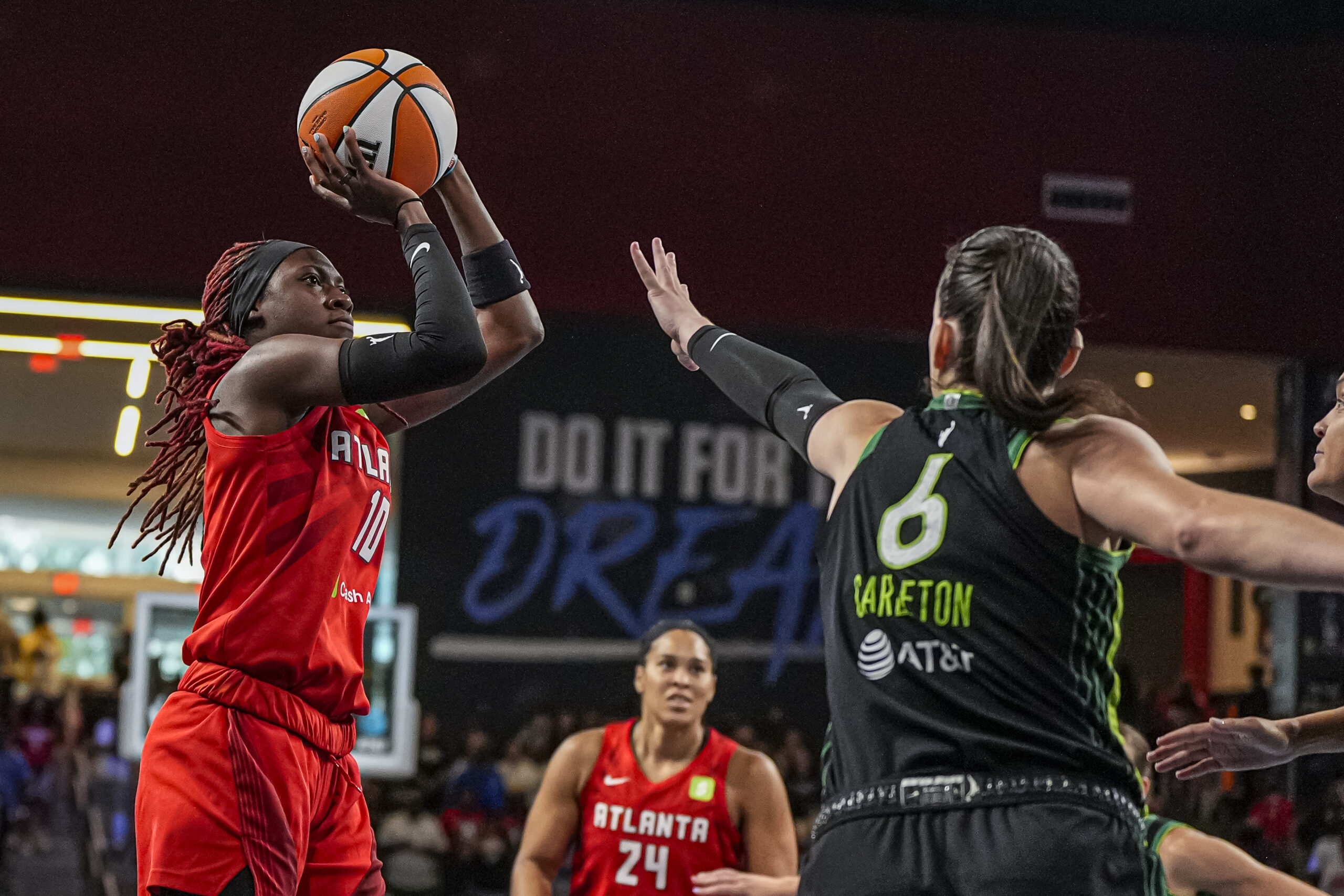 Aug 21, 2025; College Park, Georgia, USA; Atlanta Dream guard Rhyne Howard (10) shoots over Minnesota Lynx forward Bridget Carleton (6) during the first half at Gateway Center Arena at College Park. Mandatory Credit: Dale Zanine-Imagn Images