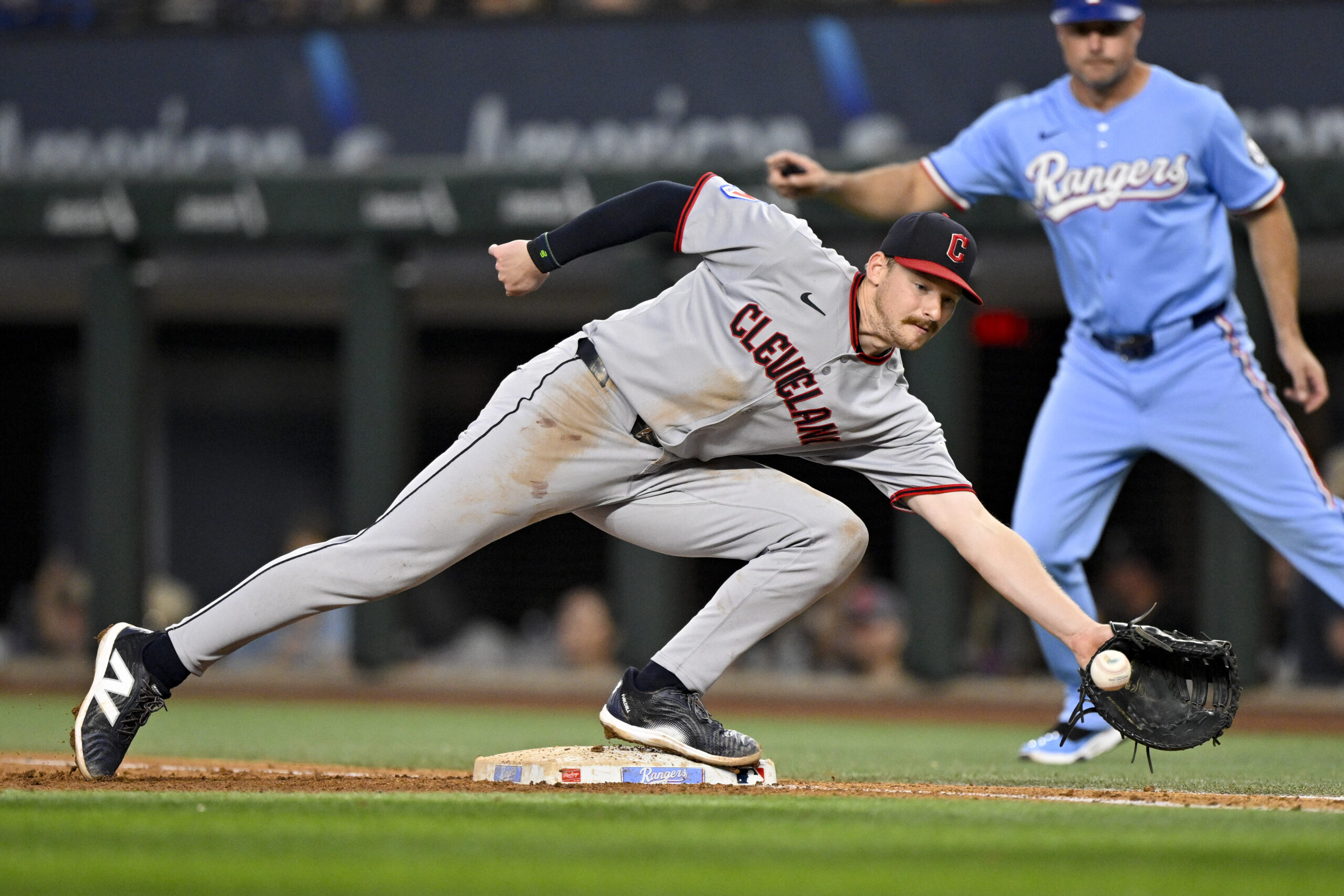 Aug 24, 2025; Arlington, Texas, USA; Cleveland Guardians first baseman Kyle Manzardo (9) fields a throw to first base during the sixth inning against the Texas Rangers at Globe Life Field. Mandatory Credit: Jerome Miron-Imagn Images