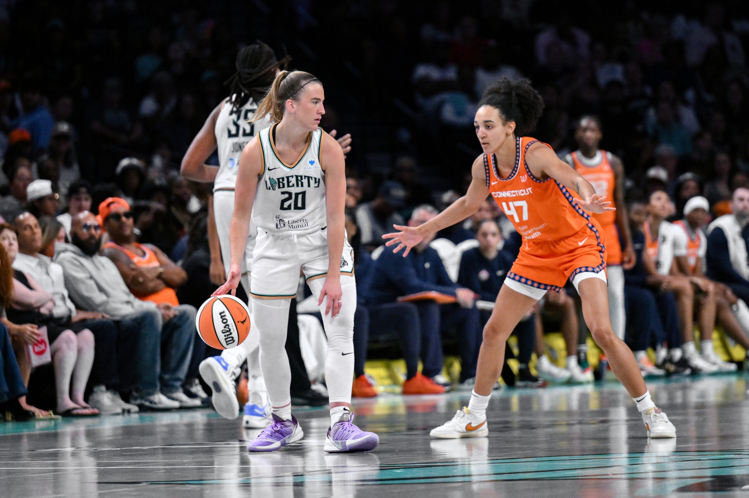 Aug 25, 2025; Brooklyn, New York, USA; New York Liberty guard Sabrina Ionescu (20) sets the play while defended by Connecticut Sun guard Leila Lacan (47) during the second half at Barclays Center. Mandatory Credit: John Jones-Imagn Images