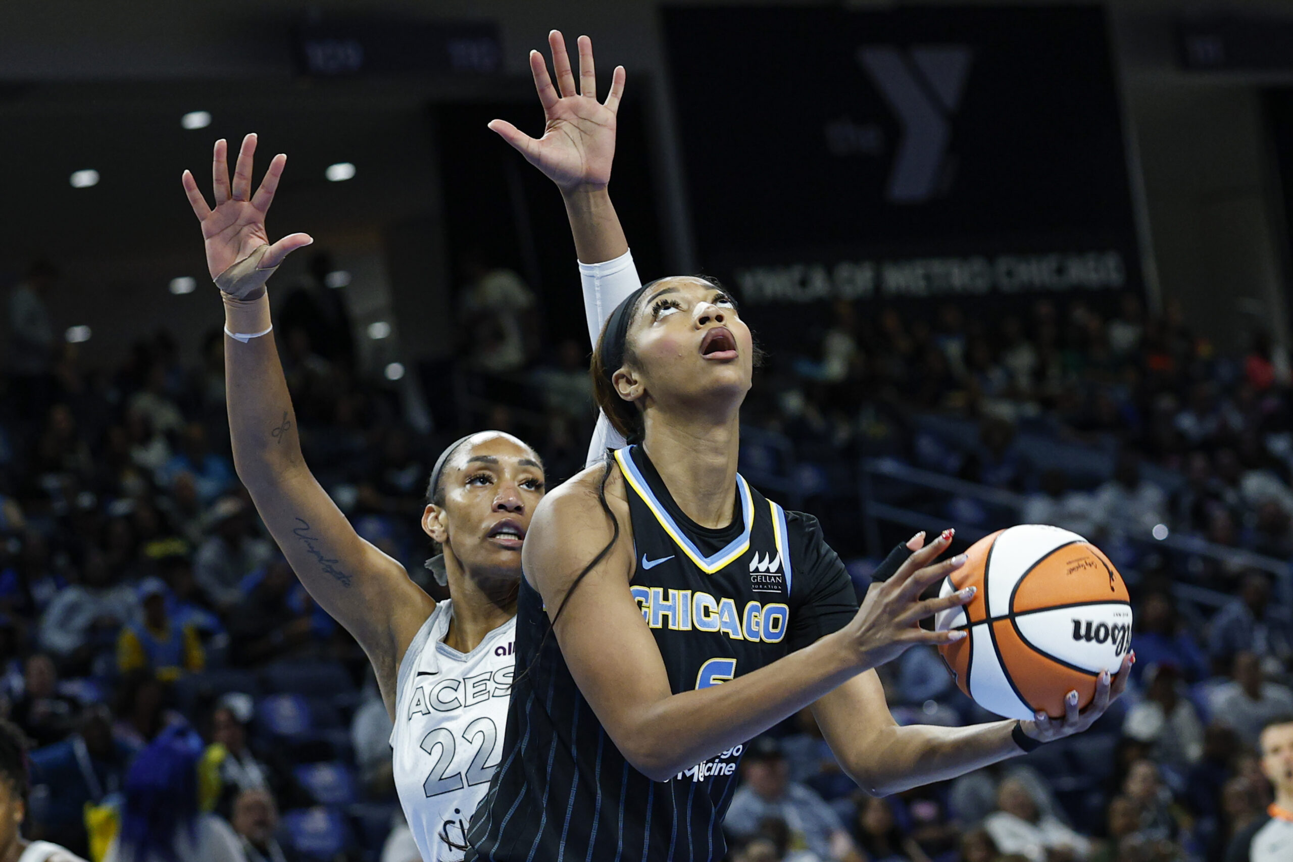 Aug 25, 2025; Chicago, Illinois, USA; Chicago Sky forward Angel Reese (5) drives to the basket against Las Vegas Aces center A'ja Wilson (22) during the first half at Wintrust Arena. Mandatory Credit: Kamil Krzaczynski-Imagn Images