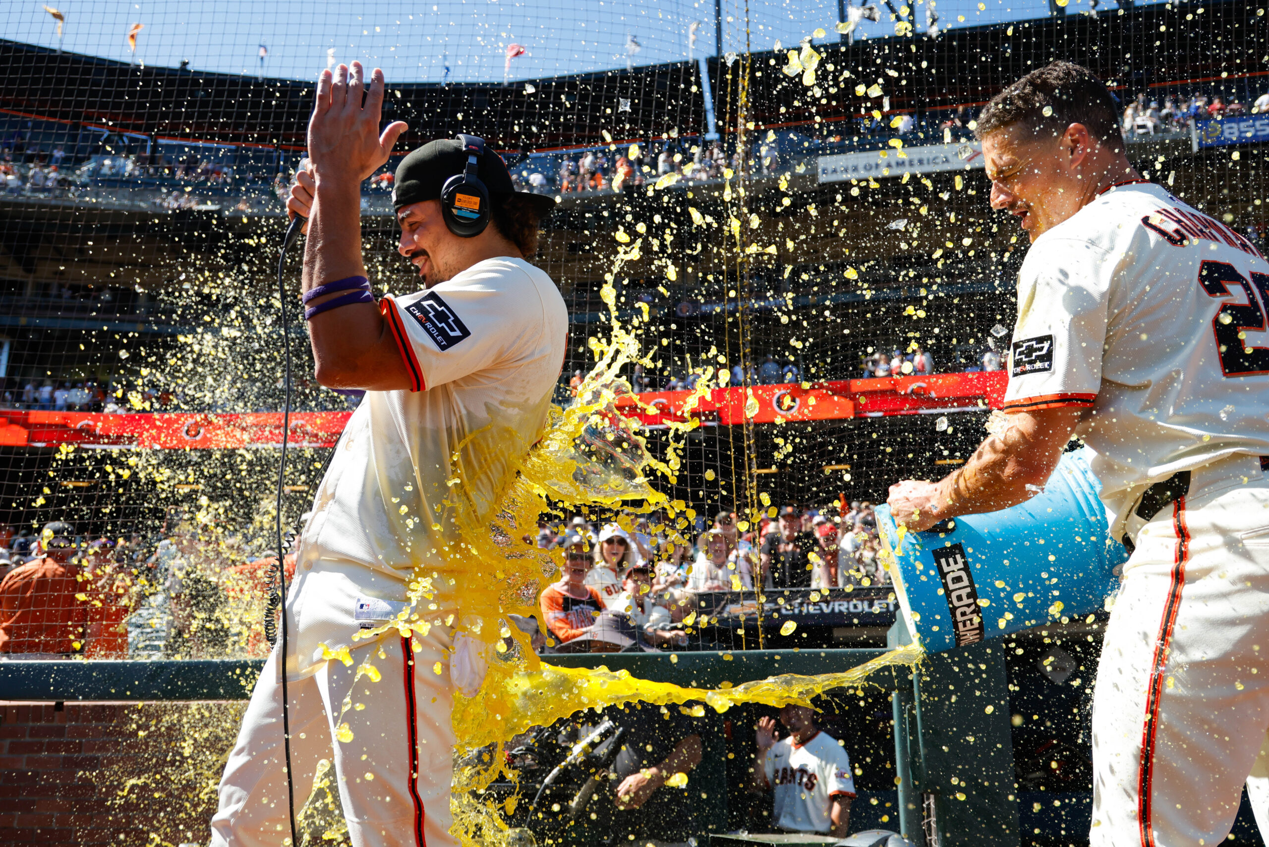 Aug 28, 2025; San Francisco, California, USA; San Francisco Giants shortstop Willy Adames (2) gets a gatorade splash by third baseman Matt Chapman (26) after the game against the Chicago Cubs  at Oracle Park. Mandatory Credit: Sergio Estrada-Imagn Images