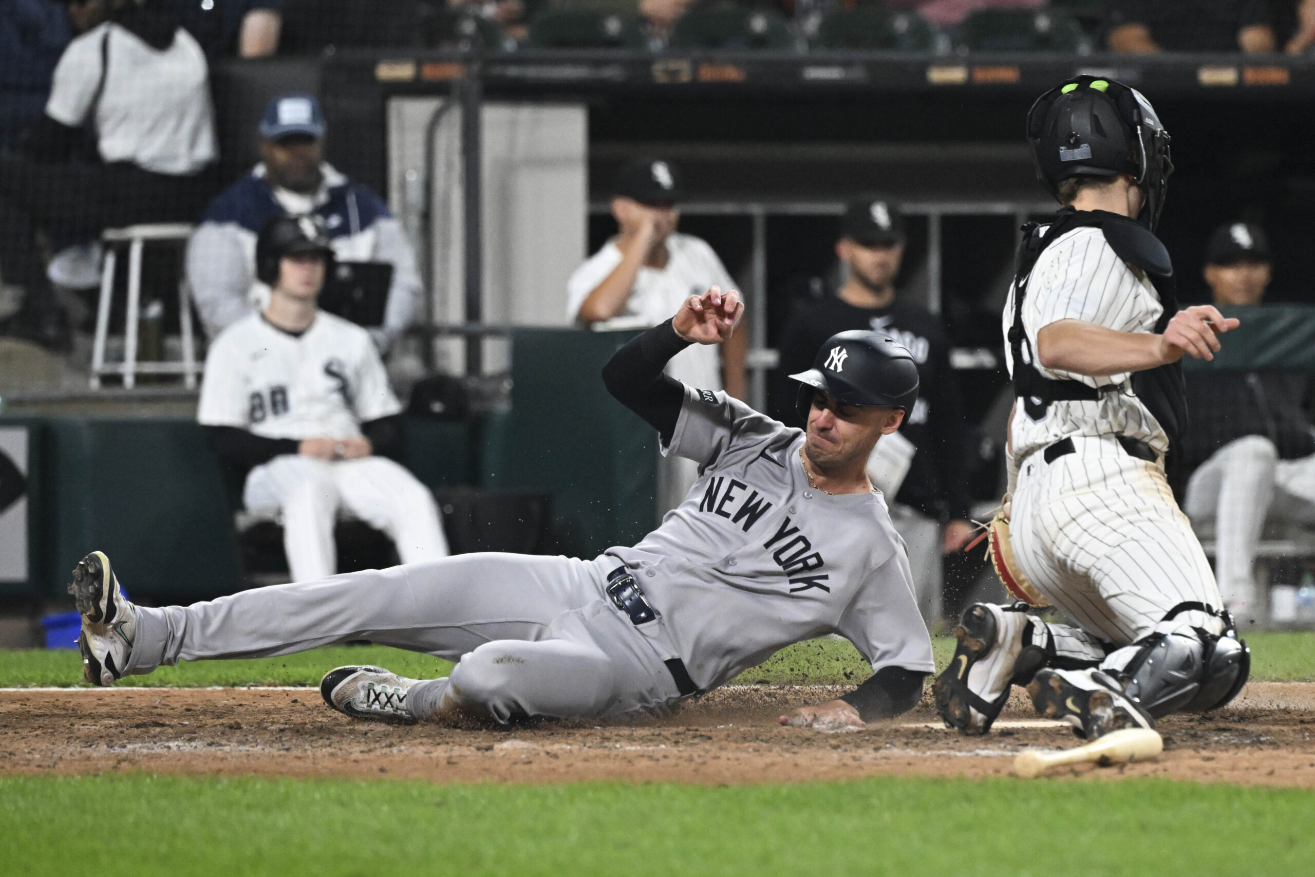 Aug 28, 2025; Chicago, Illinois, USA;  New York Yankees outfielder Cody Bellinger (35) slides safely past Chicago White Sox catcher Kyle Teel (8) during the ninth inning at Rate Field. Mandatory Credit: Matt Marton-Imagn Images