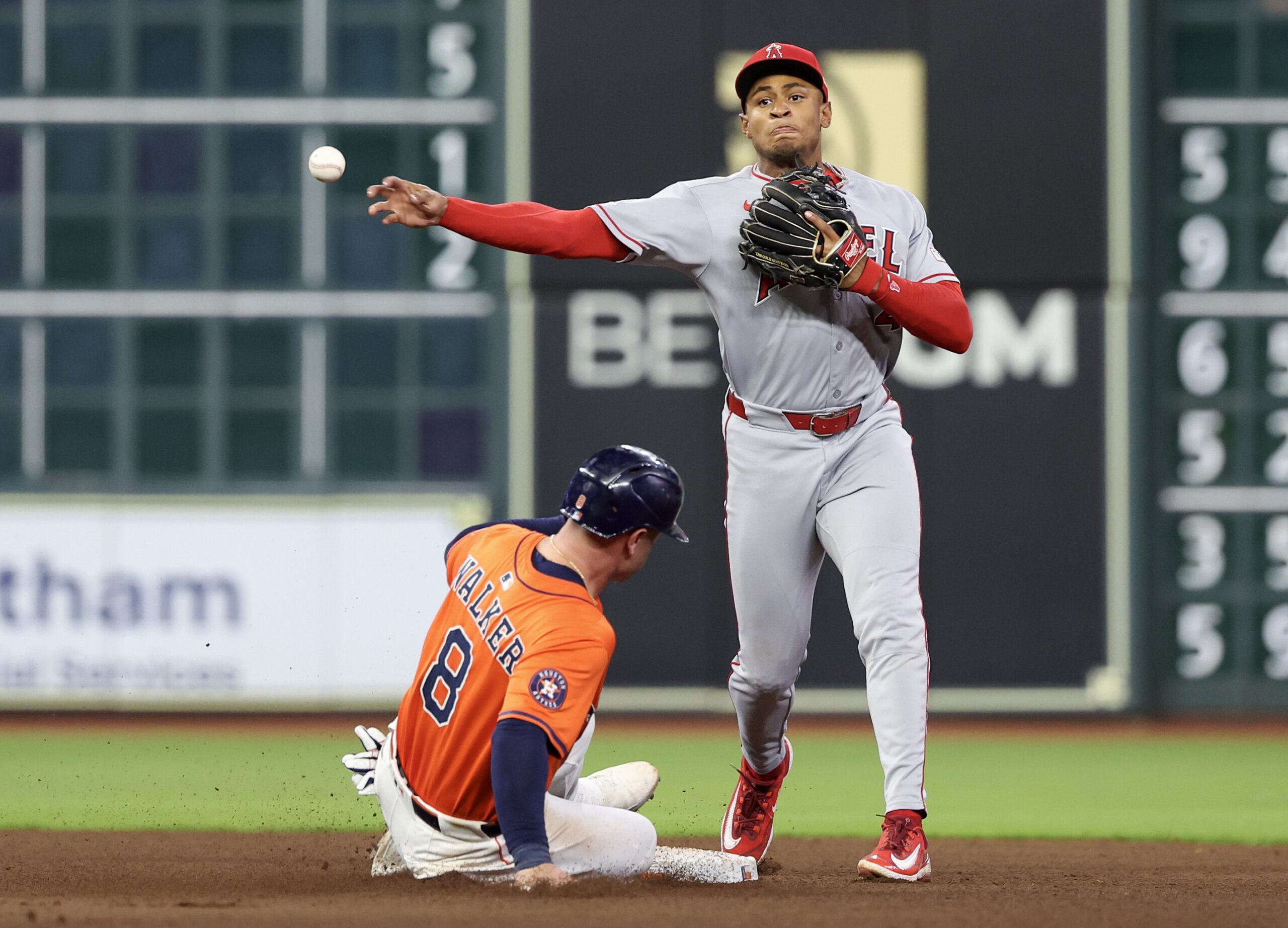 Aug 29, 2025; Houston, Texas, USA; Los Angeles Angels second baseman Christian Moore (4) forces Houston Astros first baseman Christian Walker (8) out at second base but can’t turn the double play in time in the sixth inning at Daikin Park. Mandatory Credit: Thomas Shea-Imagn Images