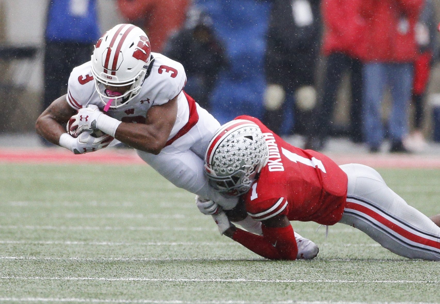 Ohio State Buckeyes cornerback Jeff Okudah (1) tackles Wisconsin Badgers wide receiver Kendric Pryor (3) during the first quarter of a NCAA Division I college football game between the Ohio State Buckeyes and the Wisconsin Badgers on Saturday, October 26, 2019 at Ohio Stadium in Columbus, Ohio. [Joshua A. Bickel/Dispatch]

Osu19wis Jb 30