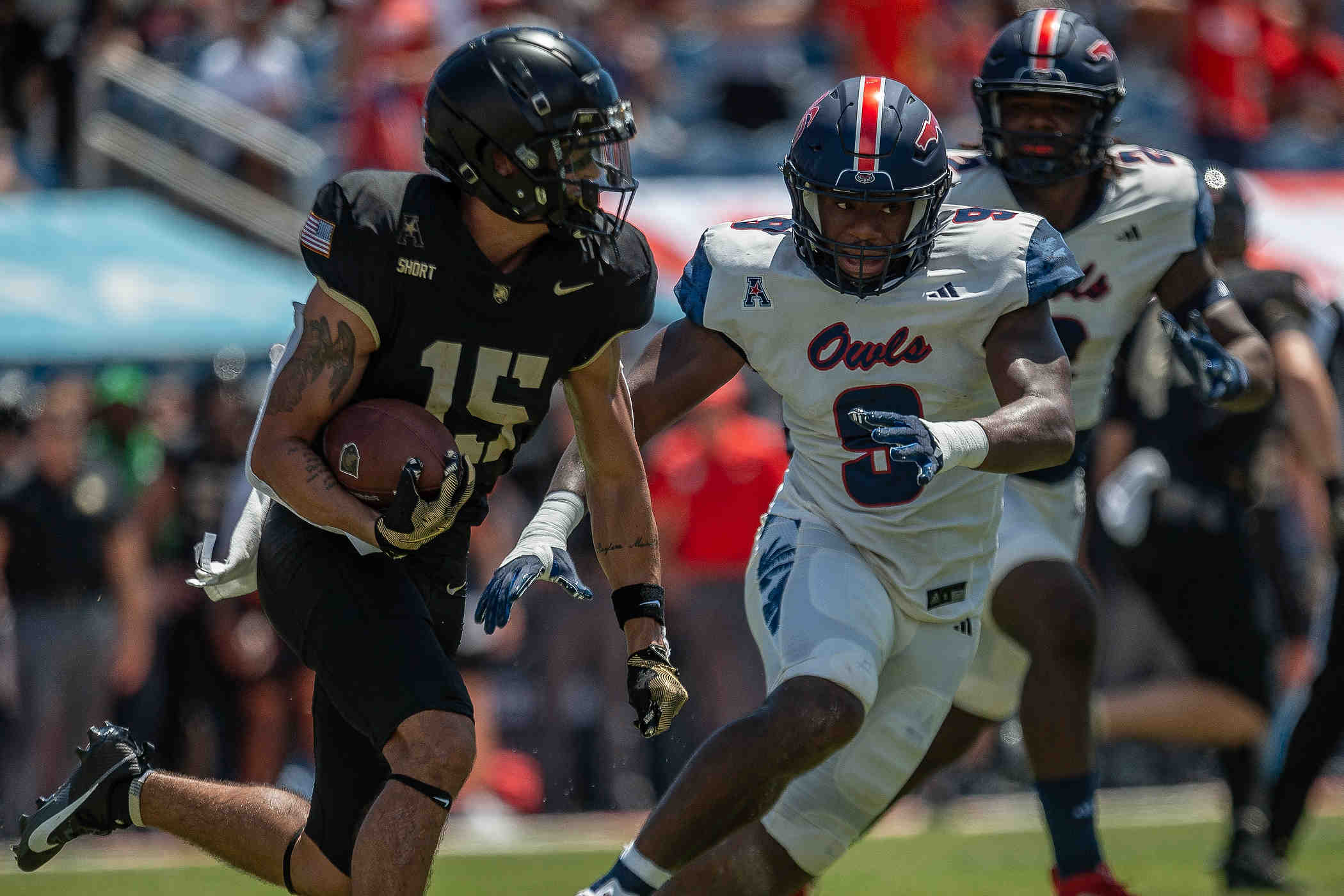 Army Black Knights running back Noah Short #15 carries the ball as Florida Atlantic University Owls linebacker Desmond Tisdol #9 looks to tackle during college football action as the Florida Atlantic University Owls host Army's Black Knights on September 7, 2024, in Boca Raton, Fla. Army led 14-7 at halftime.