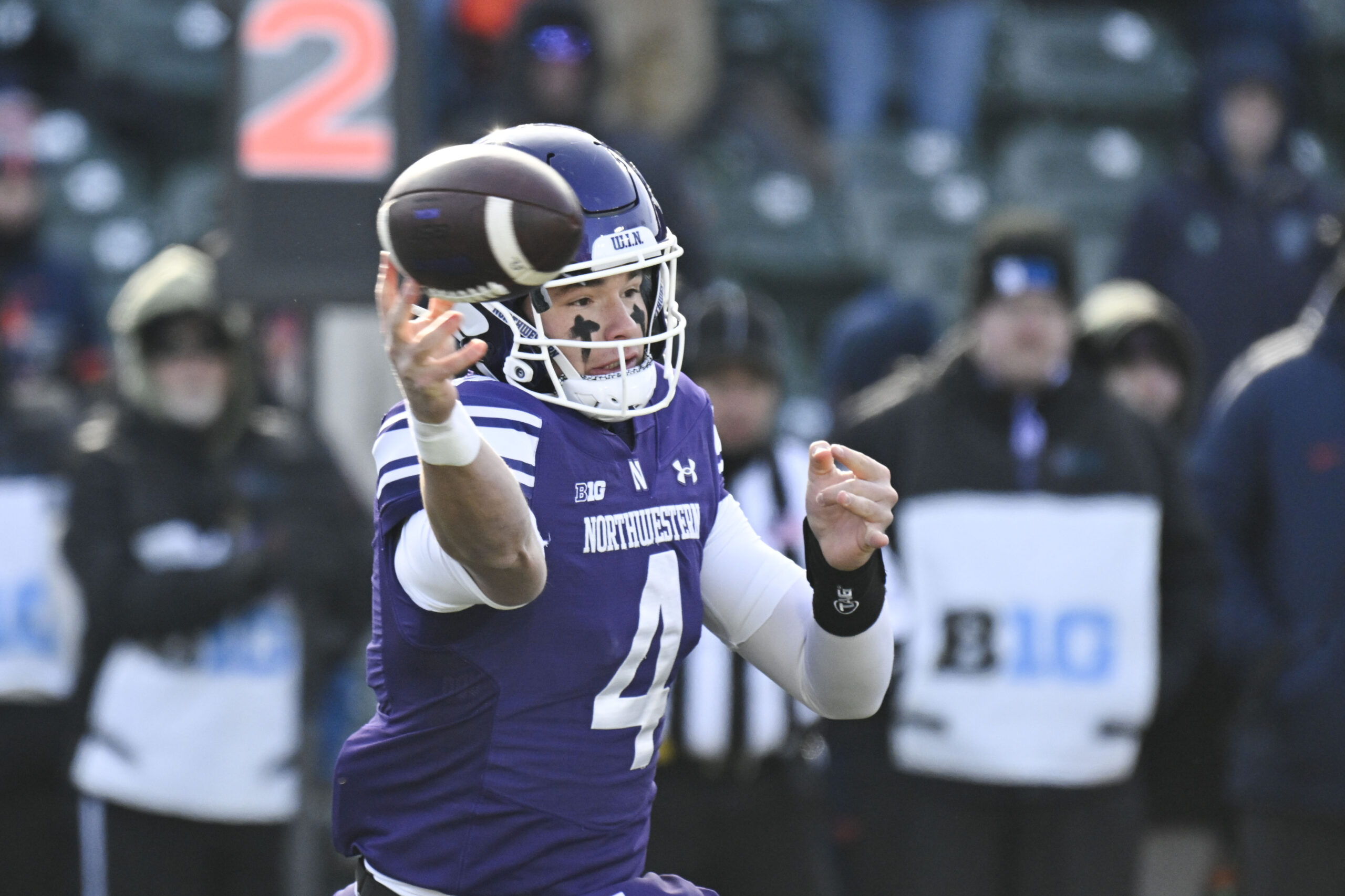 Nov 30, 2024; Chicago, Illinois, USA;  Northwestern Wildcats quarterback Ryan Boe (4) passes the ball against Illinois Fighting Illini  during the first half at Wrigley Field. Mandatory Credit: Matt Marton-Imagn Images