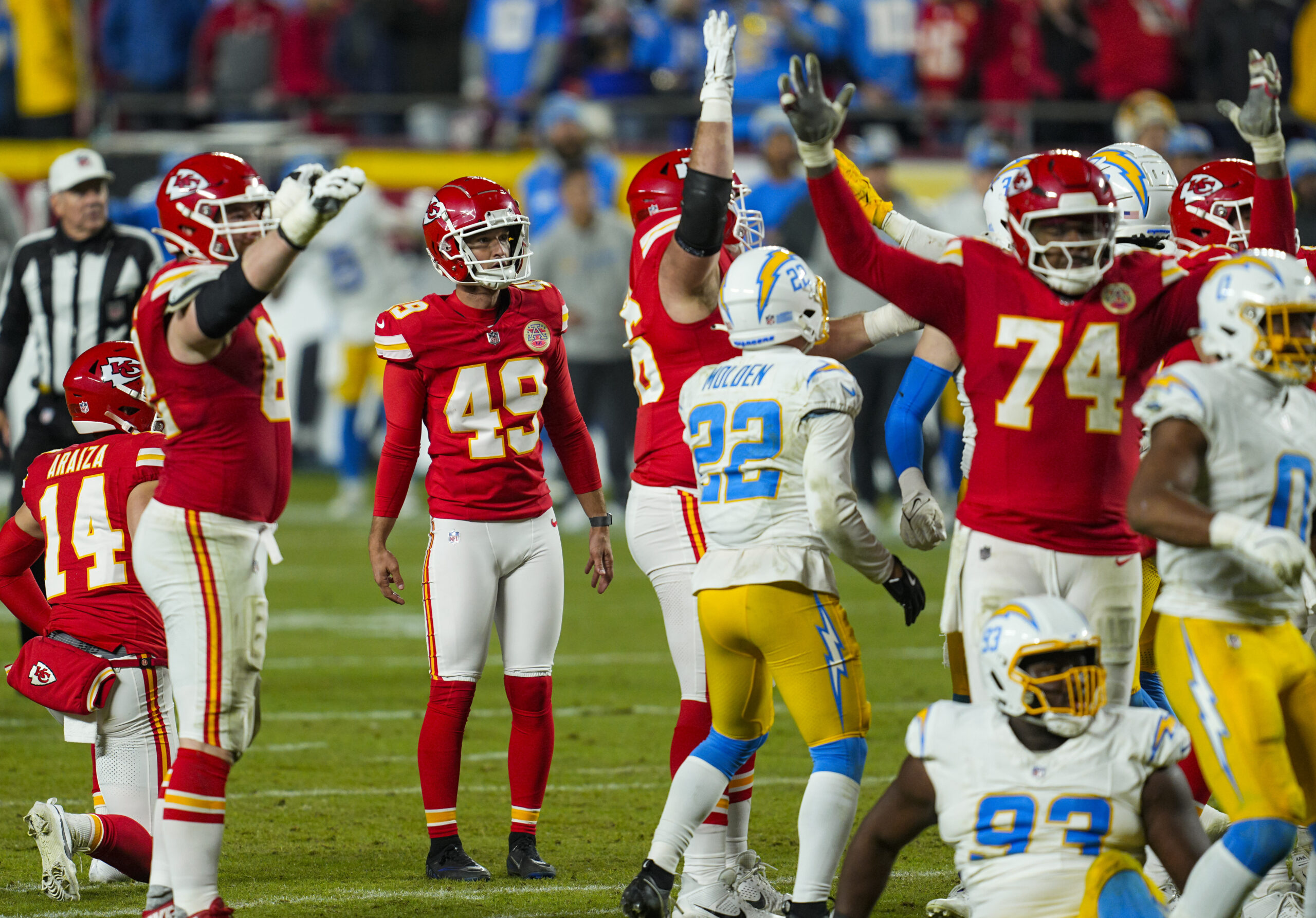 Dec 8, 2024; Kansas City, Missouri, USA; Kansas City Chiefs place kicker Matthew Wright (49) watches a game winning field goal as time expires against the Los Angeles Chargers at GEHA Field at Arrowhead Stadium. Mandatory Credit: Jay Biggerstaff-Imagn Images
