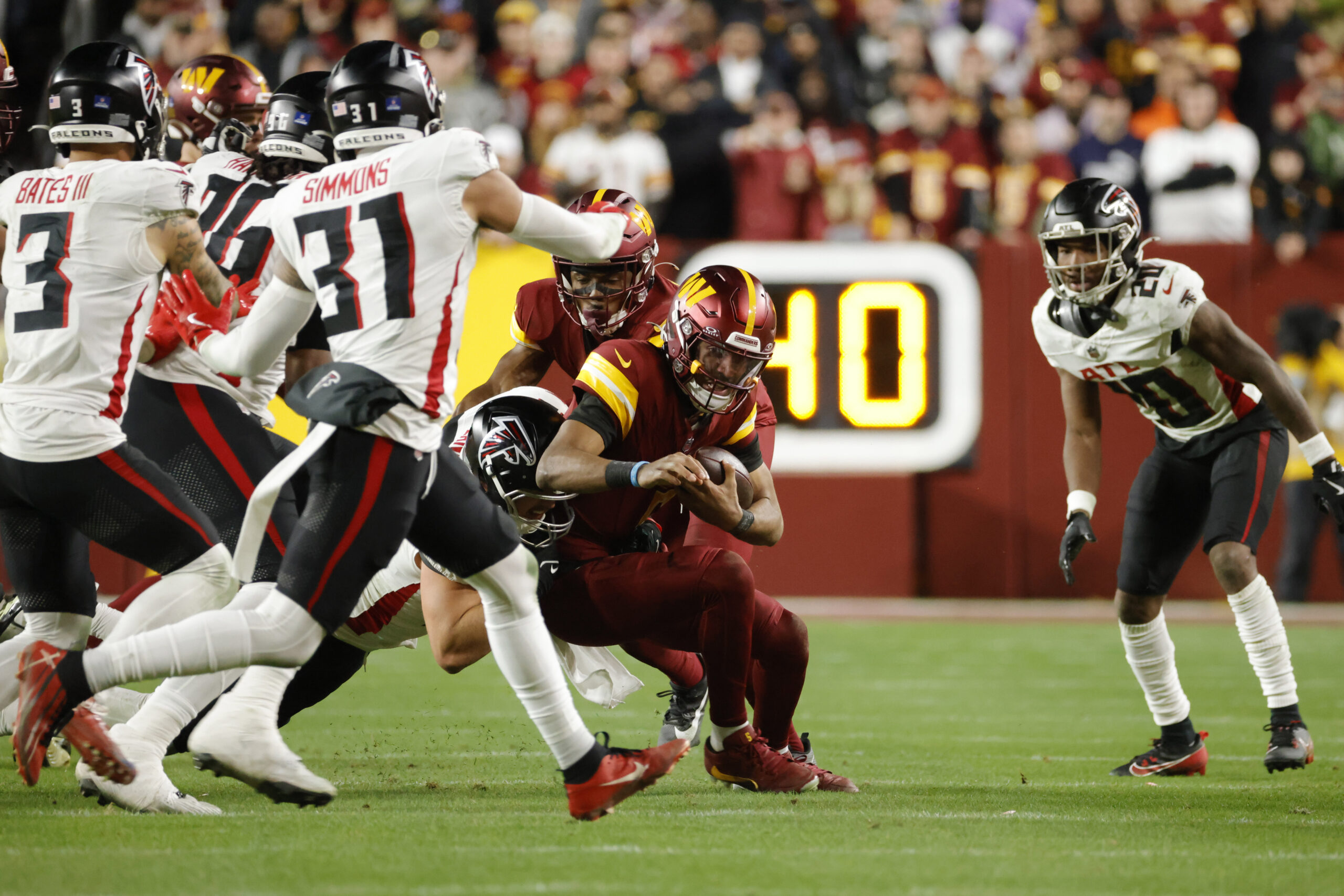 Dec 29, 2024; Landover, Maryland, USA; Washington Commanders quarterback Jayden Daniels (5) runs with the ball against the Atlanta Falcons during the second half at Northwest Stadium. Mandatory Credit: Amber Searls-Imagn Images