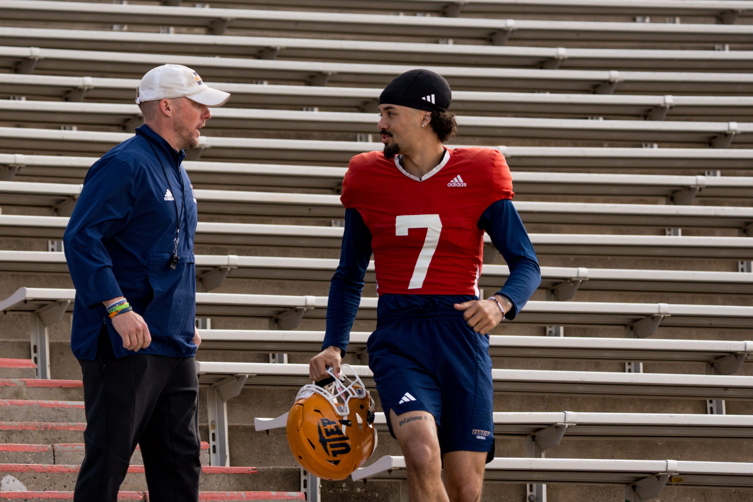 UTEP sophomore quarterback Malachi Nelson (7) and head coach Scotty Walden talk as they walk down from the Mine Shaft to the field for spring practice at the Sun Bowl in El Paso, Texas, on Friday, April 4, 2025.