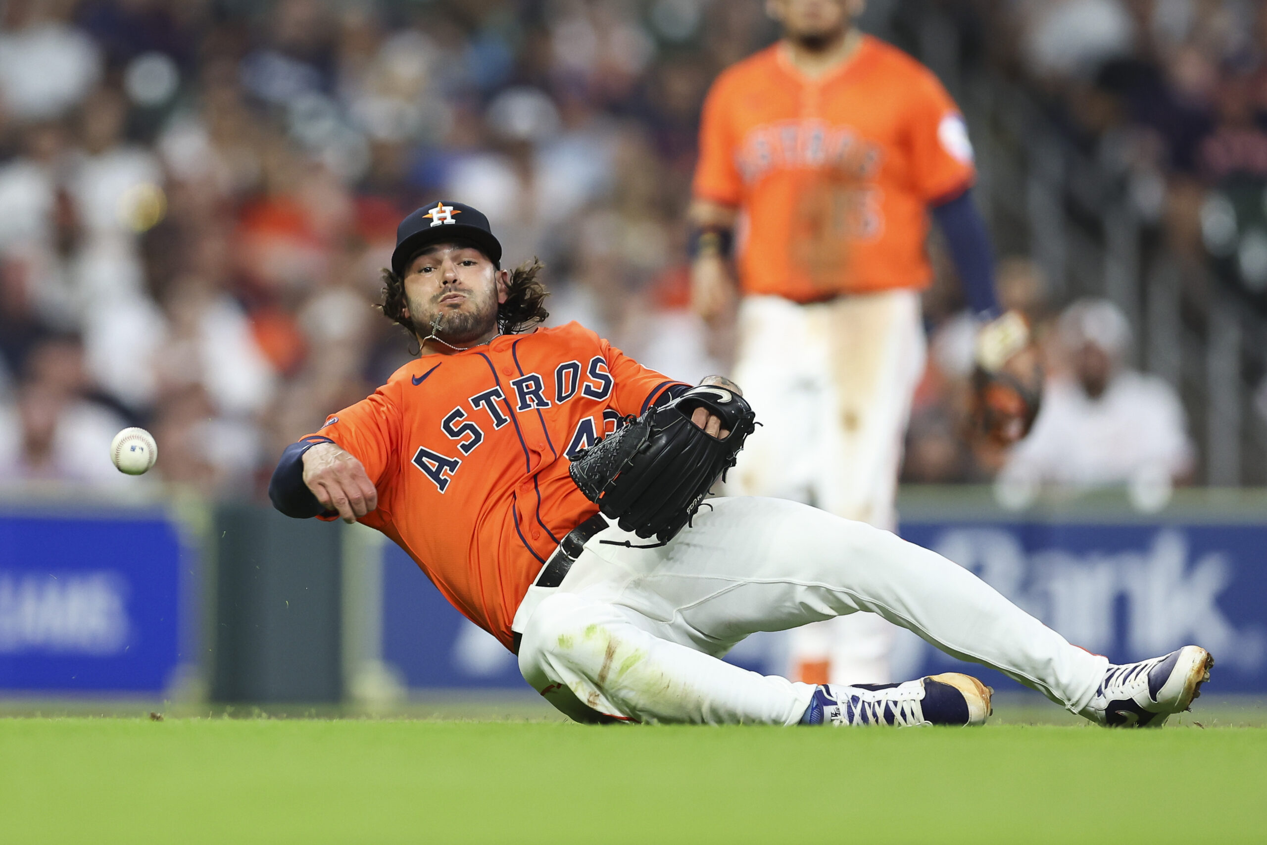 Jul 11, 2025; Houston, Texas, USA; Houston Astros starting pitcher Lance McCullers Jr. (43) throws from the ground but is unable to get an out on an infield single by Texas Rangers first baseman Jake Burger (not pictured) during the third inning at Daikin Park. Mandatory Credit: Troy Taormina-Imagn Images