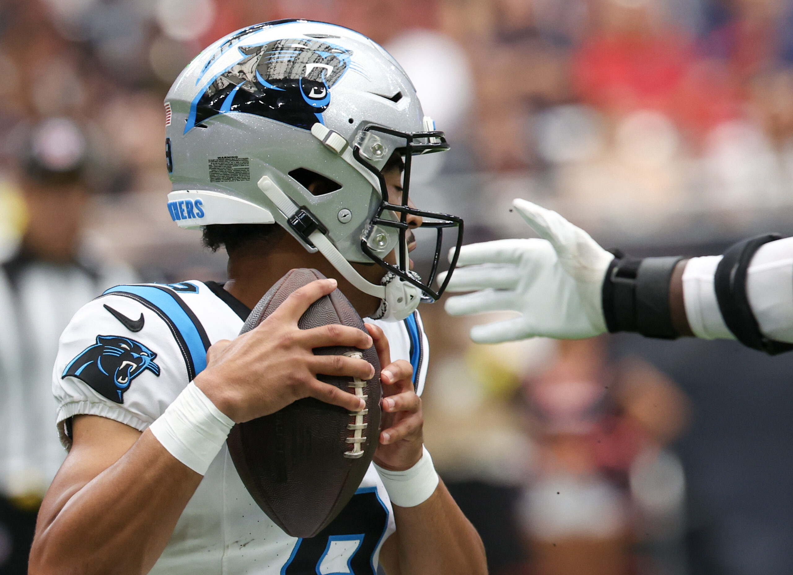 Aug 16, 2025; Houston, Texas, USA; Carolina Panthers quarterback Bryce Young (9) tries to avoid the grip of Houston Texans defensive end Will Anderson Jr. (51) in the first quarter at NRG Stadium. Mandatory Credit: Thomas Shea-Imagn Images