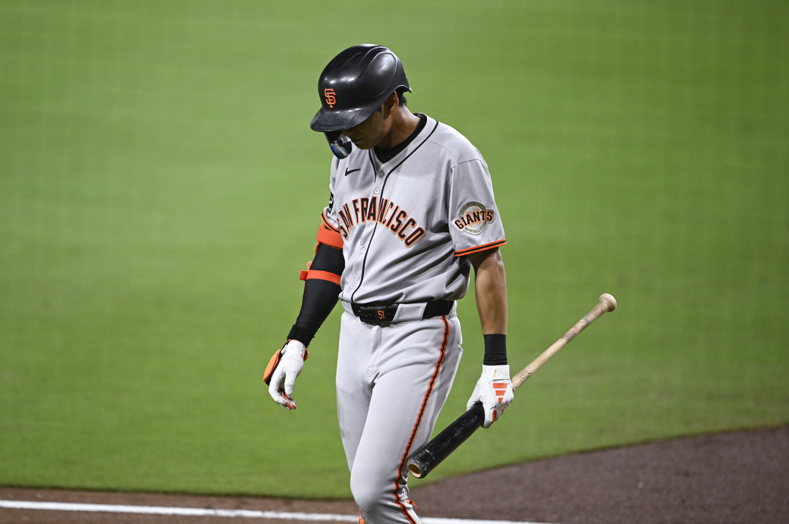 Aug 20, 2025; San Diego, California, USA; San Francisco Giants center fielder Jung Hoo Lee (51) walks back to the dugout after striking out during the seventh inning against the San Diego Padres at Petco Park. Mandatory Credit: Denis Poroy-Imagn Images