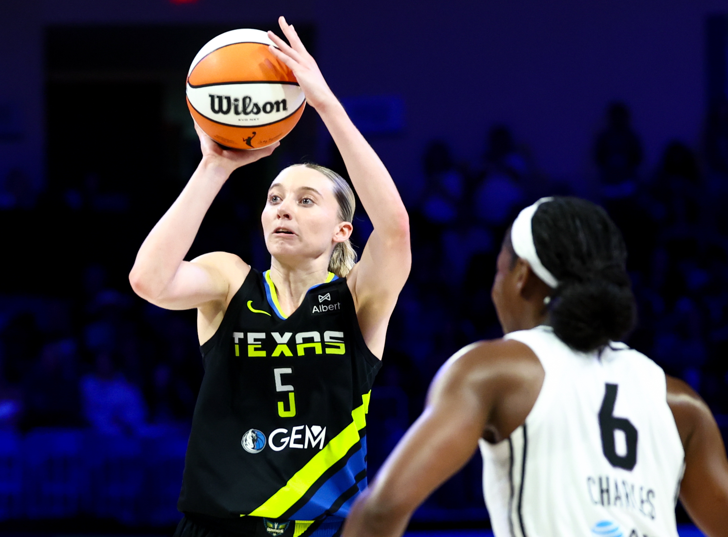 Aug 24, 2025; Arlington, Texas, USA;  Dallas Wings guard Paige Bueckers (5) shoots over Golden State Valkyries guard Kaila Charles (6) during the second half at College Park Center. Mandatory Credit: Kevin Jairaj-Imagn Images
