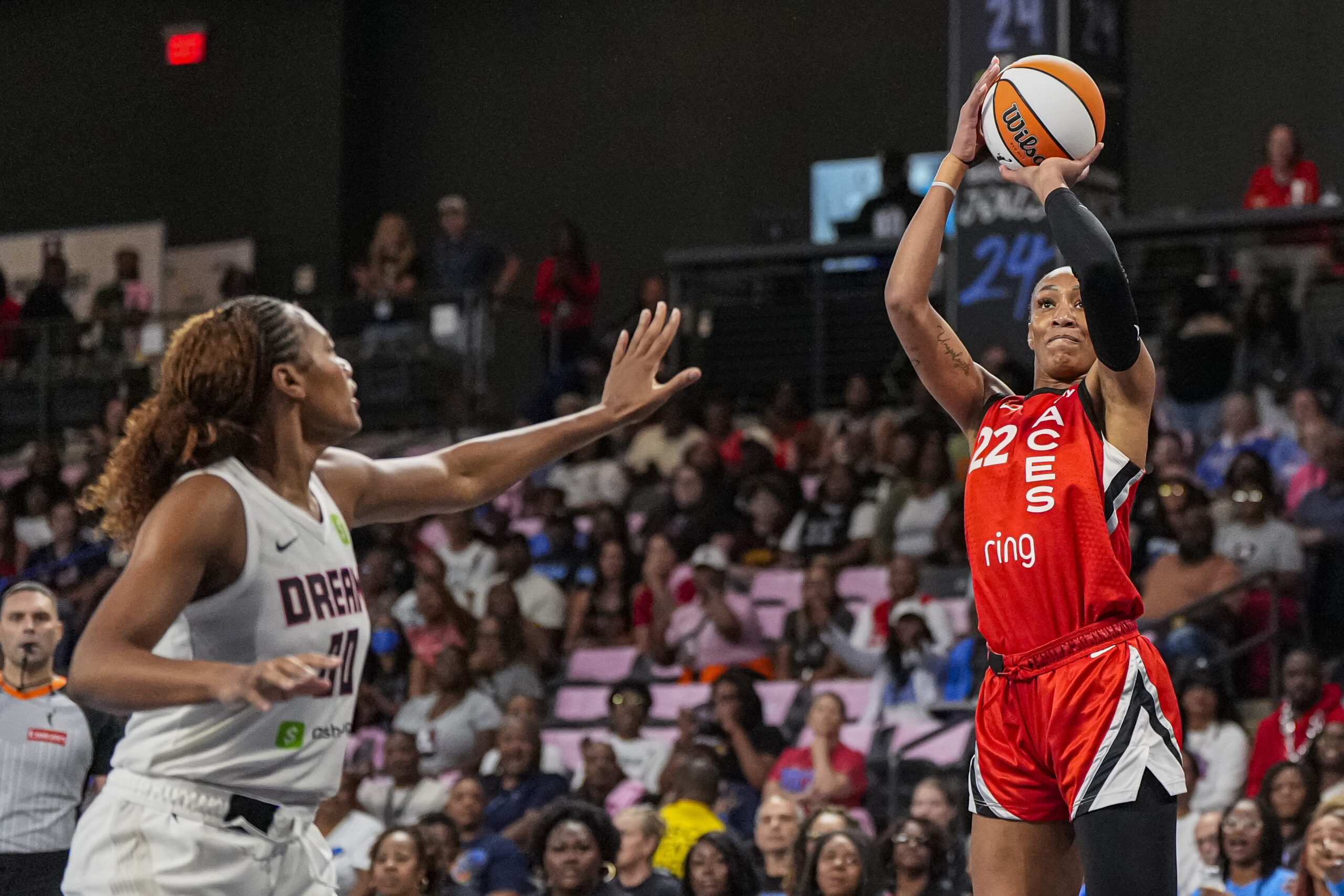Aug 27, 2025; College Park, Georgia, USA; Las Vegas Aces center A'ja Wilson (22) shoots over Atlanta Dream forward Naz Hillmon (00) during the first half at Gateway Center Arena at College Park. Mandatory Credit: Dale Zanine-Imagn Images
