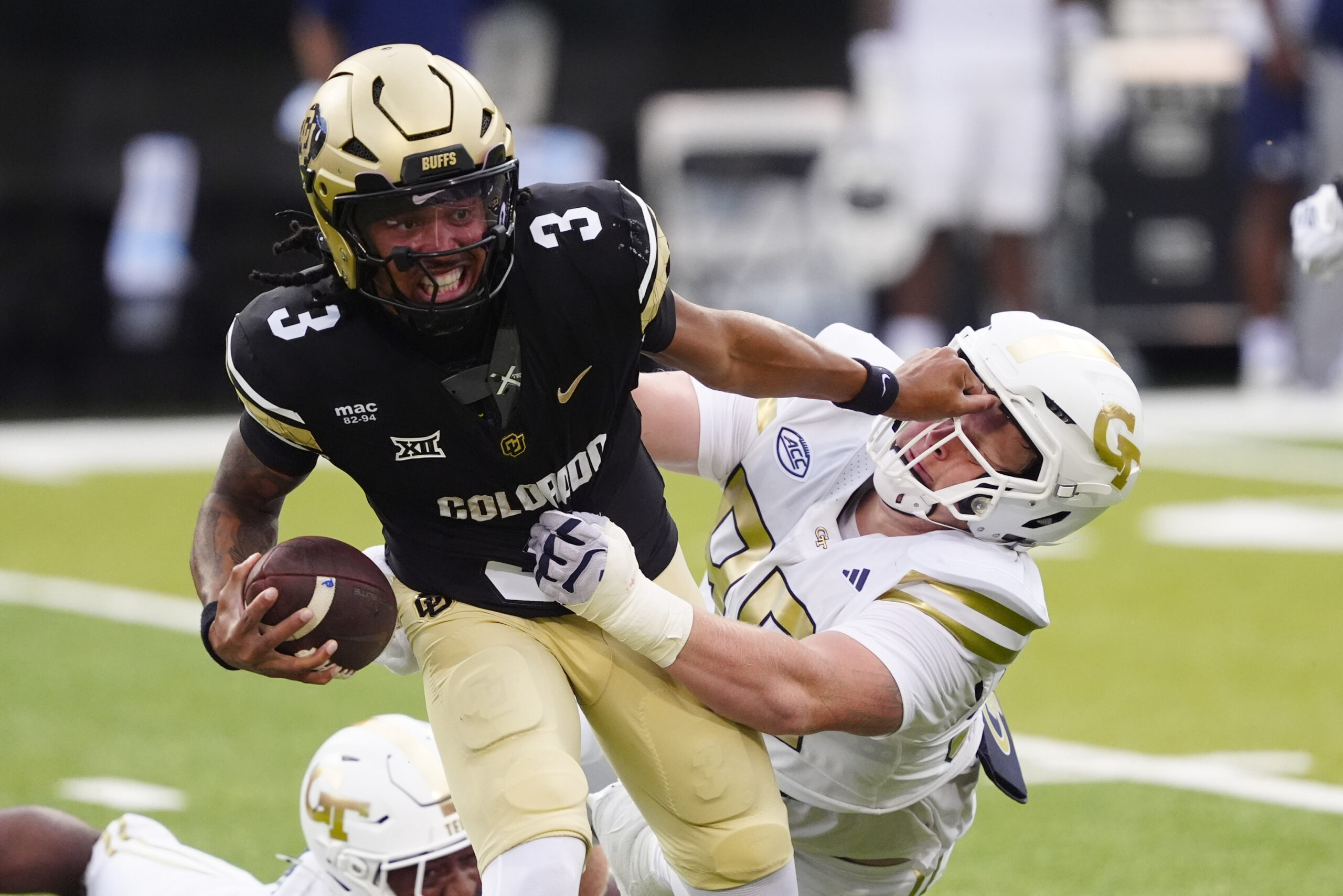 Aug 29, 2025; Boulder, Colorado, USA; Colorado Buffaloes quarterback Kaidon Salter (3) stiff arms Georgia Tech Yellow Jackets defensive lineman Jordan van den Berg (99) in the second quarter at Folsom Field. Mandatory Credit: Ron Chenoy-Imagn Images