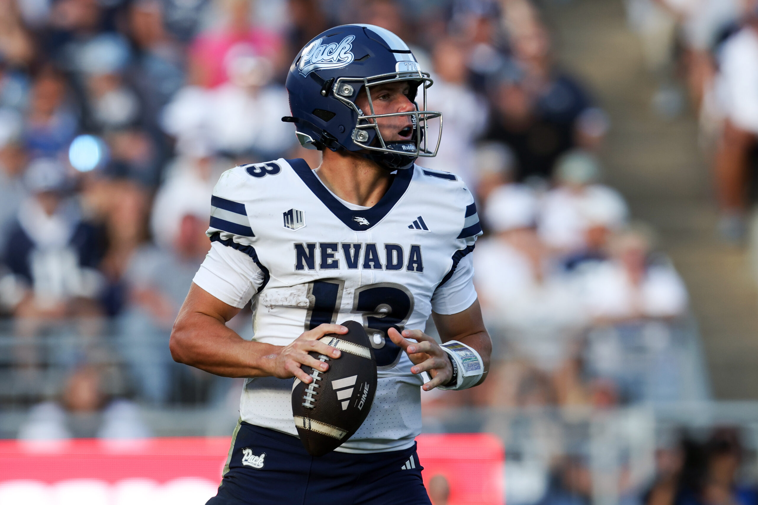 Aug 30, 2025; University Park, Pennsylvania, USA; Nevada Wolf Pack quarterback Chubba Purdy (13) drops back in the pocket while looking to throw the ball during the third quarter against the Penn State Nittany Lions at Beaver Stadium. Penn State defeated Nevada 46-9. Mandatory Credit: Matthew O'Haren-Imagn Images