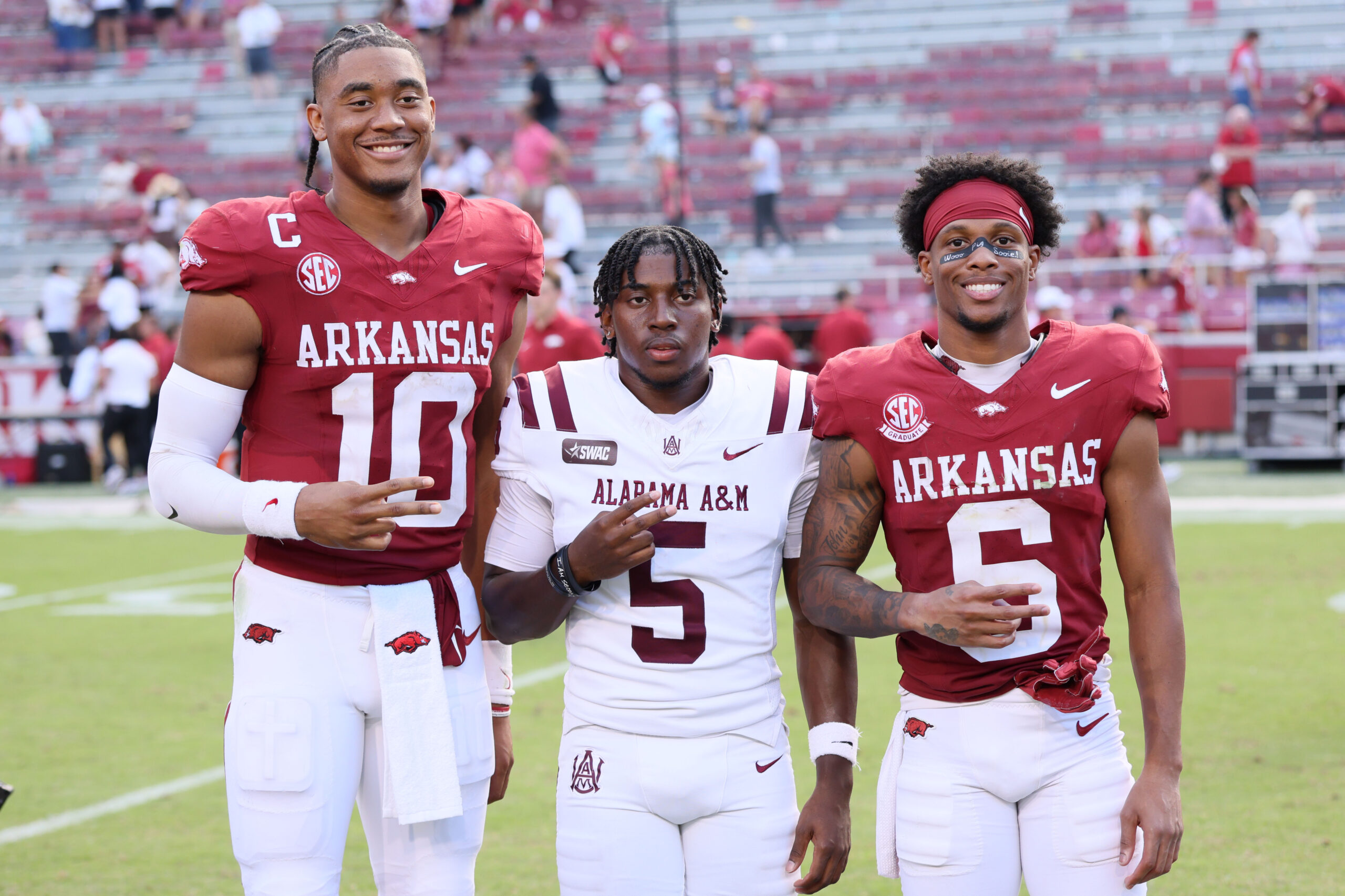 Aug 30, 2025; Fayetteville, Arkansas, USA; Arkansas Razorbacks quarterback Taylen Green (10) Alabama A&M Bulldogs wide receiver Myles Parker (5) and Razorbacks wide receiver Raylen Sharpe (6) pose for a photo after the game at Donald W. Reynolds Razorback Stadium. Mandatory Credit: Nelson Chenault-Imagn Images