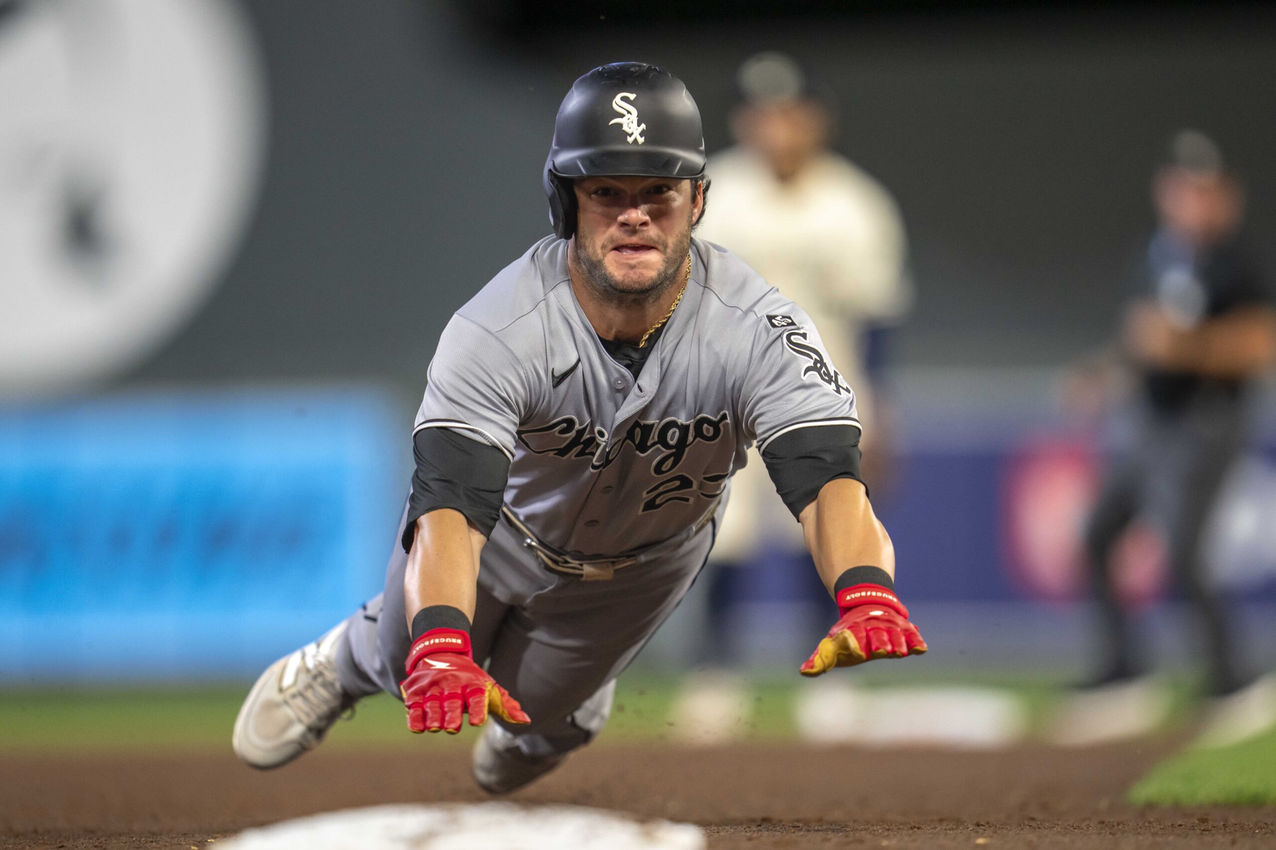 Sep 2, 2025; Minneapolis, Minnesota, USA; Chicago White Sox left fielder Andrew Benintendi (23) slides into third base safely after a fly ball against the Minnesota Twins in the sixth inning at Target Field. Mandatory Credit: Jesse Johnson-Imagn Images