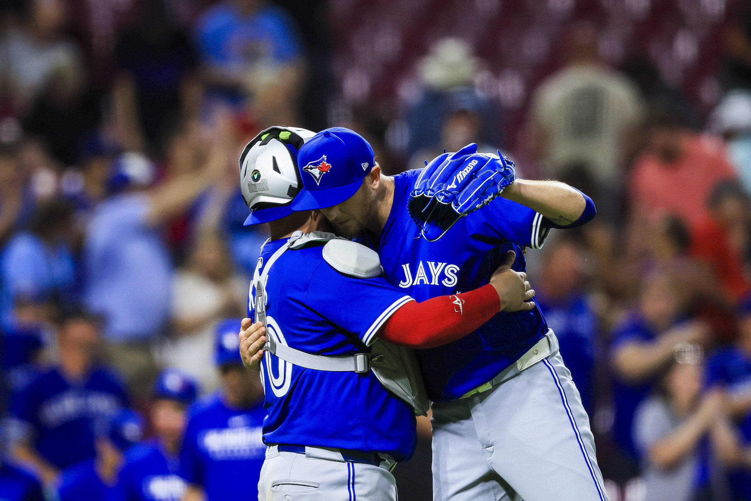 Sep 2, 2025; Cincinnati, Ohio, USA; Toronto Blue Jays catcher Alejandro Kirk (30) hugs relief pitcher Jeff Hoffman (23) after the victory over the Cincinnati Reds at Great American Ball Park. Mandatory Credit: Katie Stratman-Imagn Images