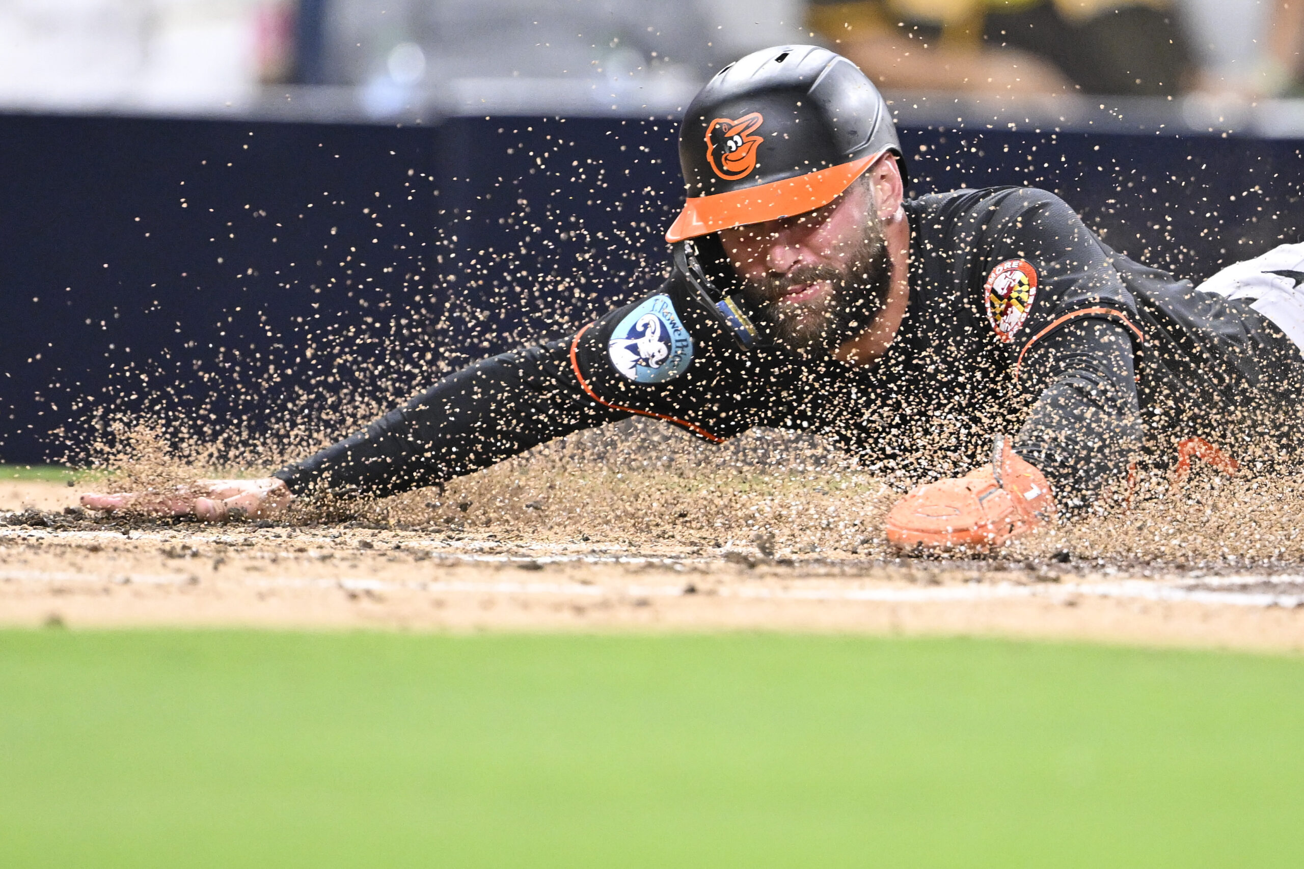 Sep 2, 2025; San Diego, California, USA; Baltimore Orioles left fielder Colton Cowser (17) slides as he scores during the third inning against the San Diego Padres at Petco Park. Mandatory Credit: Denis Poroy-Imagn Images