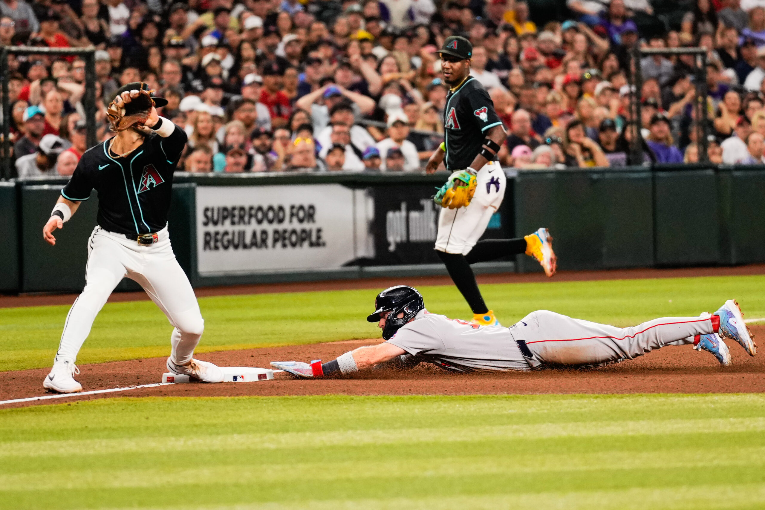 Sep 6, 2025; Phoenix, Arizona, USA;  Boston Red Sox first base Romy Gonzalez (23) slides into third during the fourth inning between the Arizona Diamondbacks and the Boston Red Sox at Chase Field. Mandatory Credit: Arianna Grainey-Imagn Images