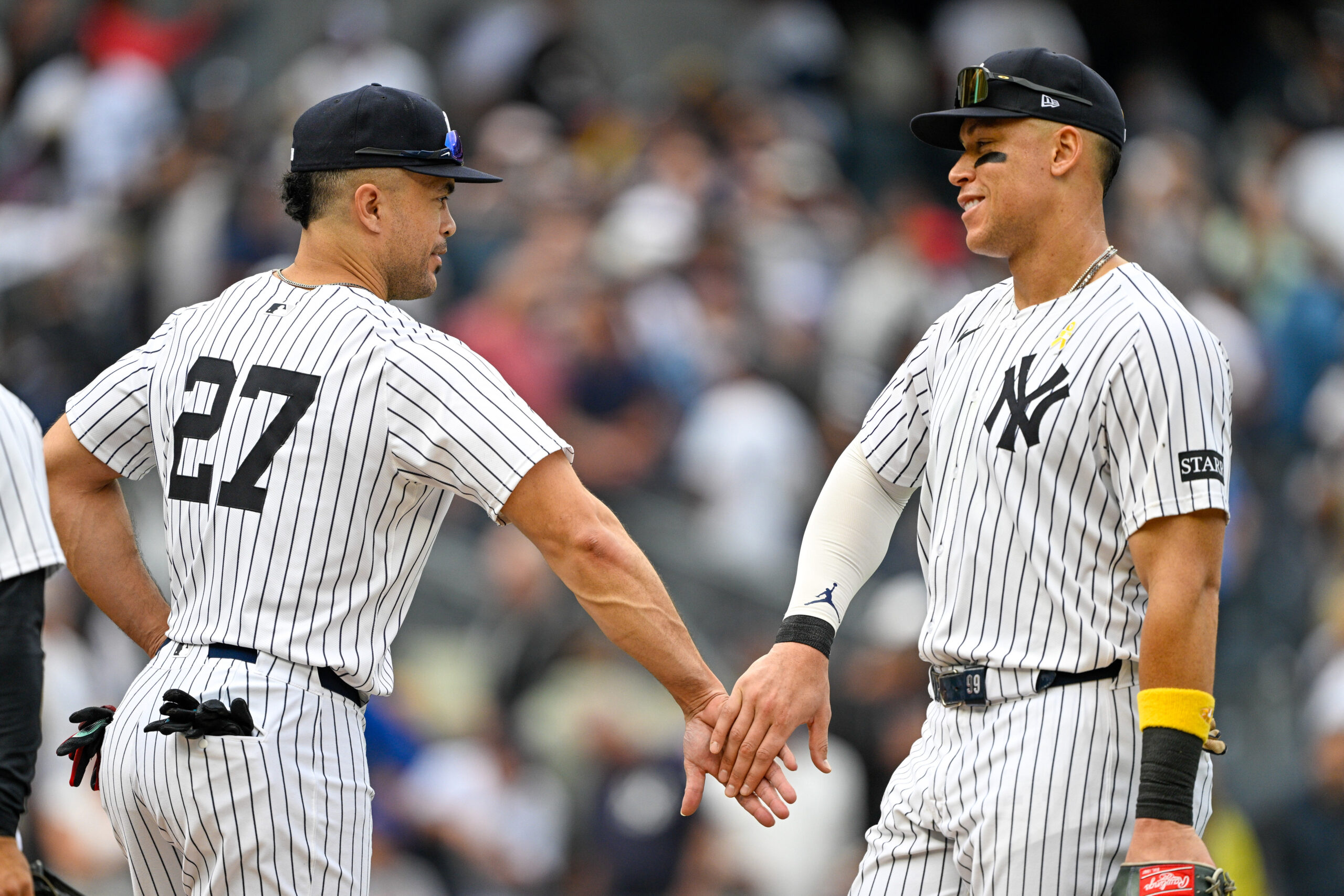 Sep 7, 2025; Bronx, New York, USA; New York Yankees designated hitter Giancarlo Stanton (27) celebrates with New York Yankees right fielder Aaron Judge (99) after the game against the Toronto Blue Jays at Yankee Stadium. Mandatory Credit: Mark Smith-Imagn Images