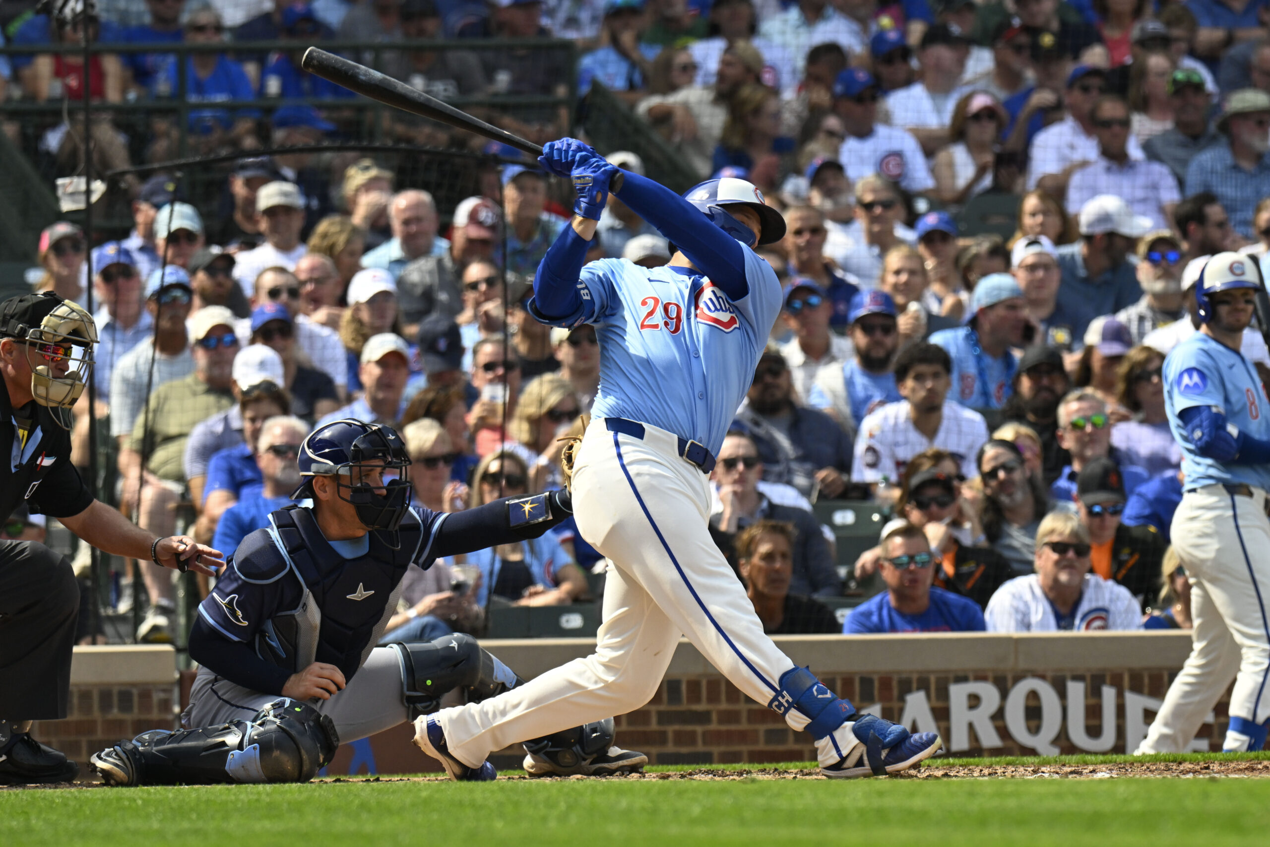 Sep 12, 2025; Chicago, Illinois, USA; Chicago Cubs first baseman Michael Busch (29) hits an RBI single against the Tampa Bay Rays during the second inning at Wrigley Field. Mandatory Credit: Matt Marton-Imagn Images