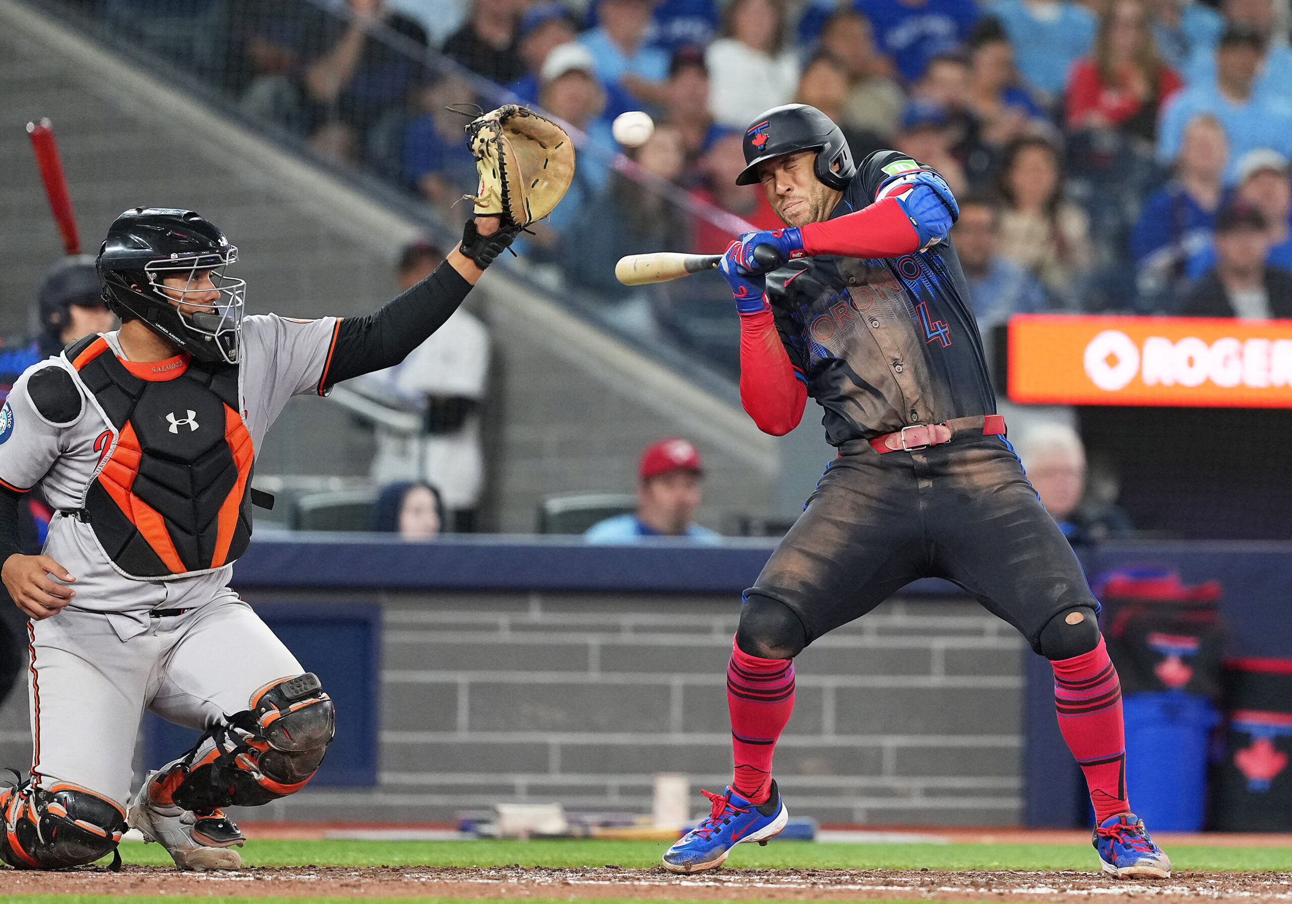 Sep 12, 2025; Toronto, Ontario, CAN; Toronto Blue Jays right fielder George Springer (4) manages to get out of the way of a high pitch against the Baltimore Orioles during the eighth inning at Rogers Centre. Mandatory Credit: Nick Turchiaro-Imagn Images