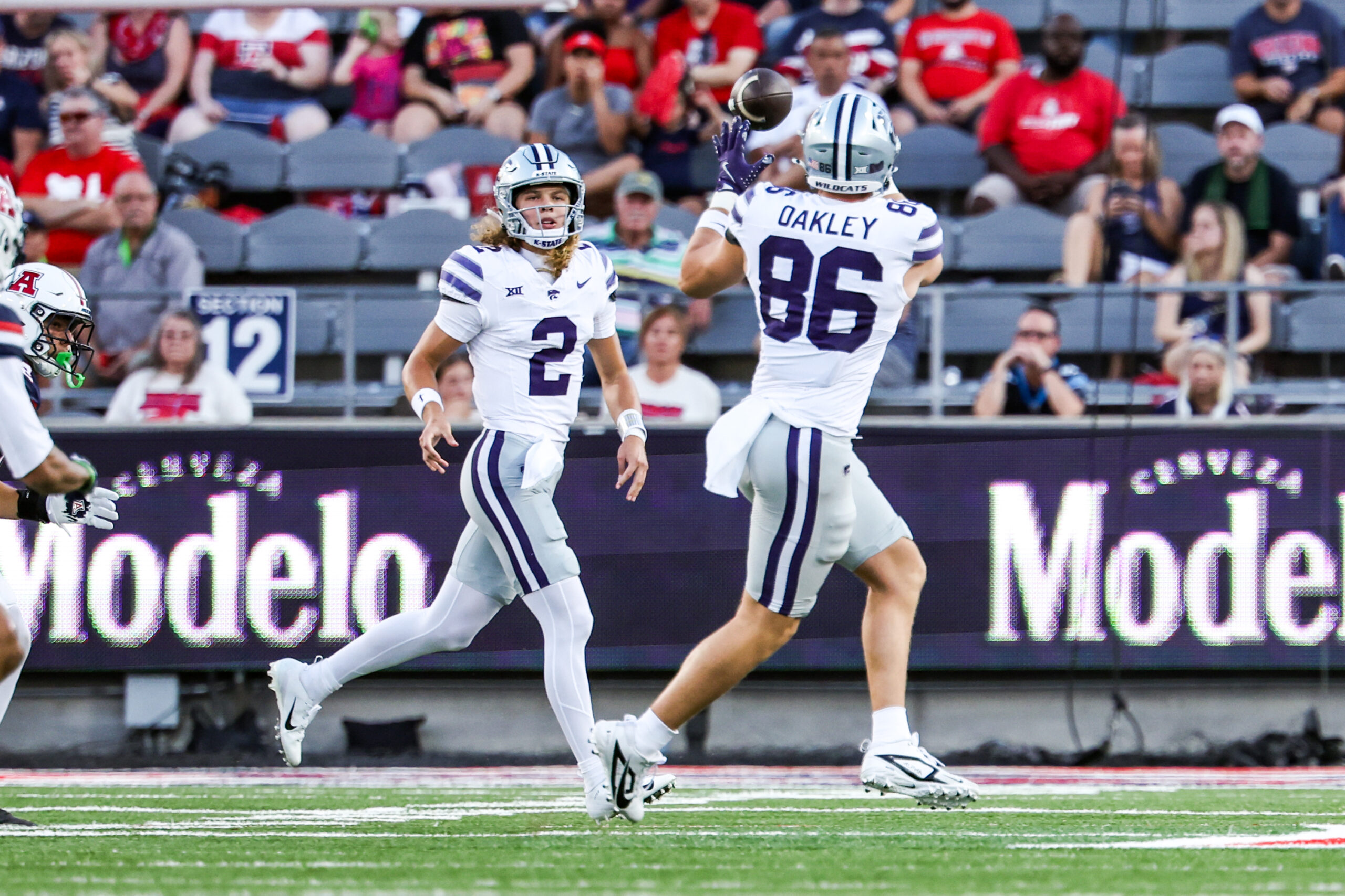 Sep 12, 2025; Tucson, Arizona, USA; Kansas State Wildcats quarterback Avery Johnson (2) throws the football to Garrett Oakley (86) during the first quarter of the game against the Arizona Wildcats at Arizona Stadium. Mandatory Credit: Aryanna Frank-Imagn Images