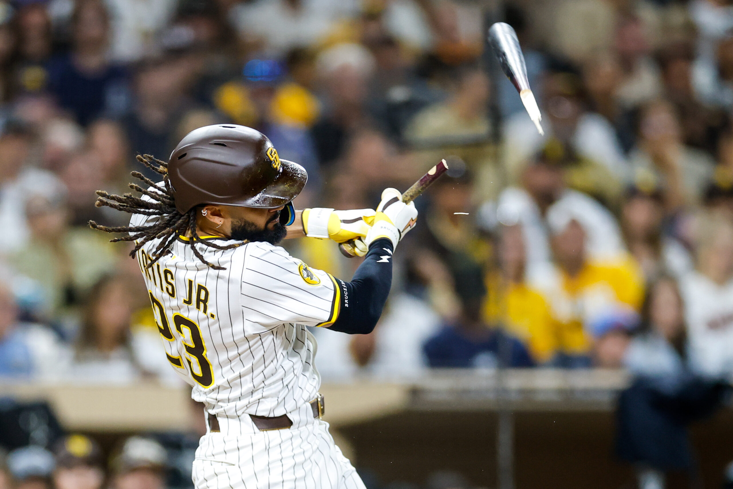 Sep 13, 2025; San Diego, California, USA; San Diego Padres right fielder Fernando Tatis Jr. (23) hits a broken bat single during the sixth inning against the Colorado Rockies at Petco Park. Mandatory Credit: David Frerker-Imagn Images