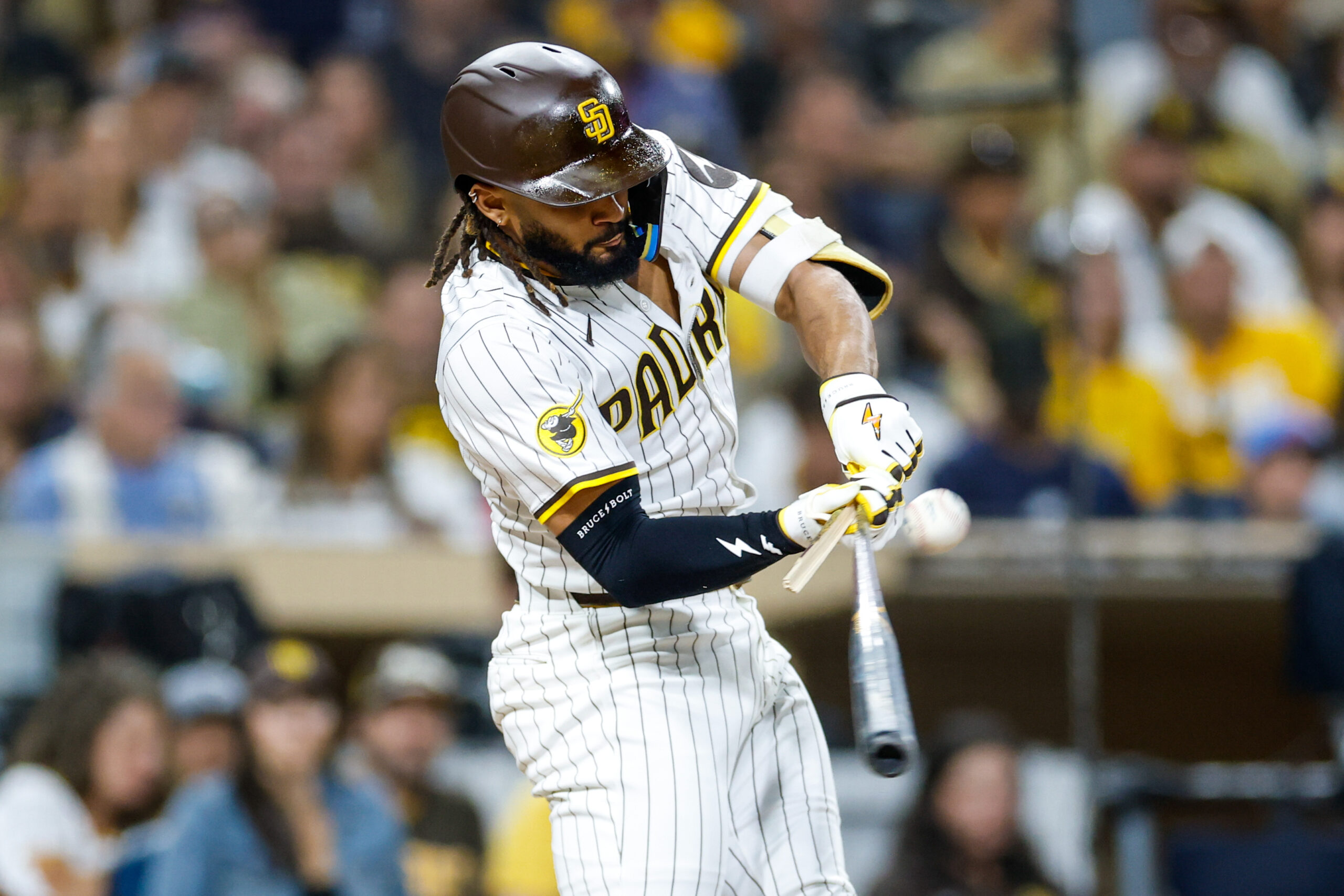 Sep 13, 2025; San Diego, California, USA; San Diego Padres right fielder Fernando Tatis Jr. (23) hits a broken bat single during the sixth inning against the Colorado Rockies at Petco Park. Mandatory Credit: David Frerker-Imagn Images