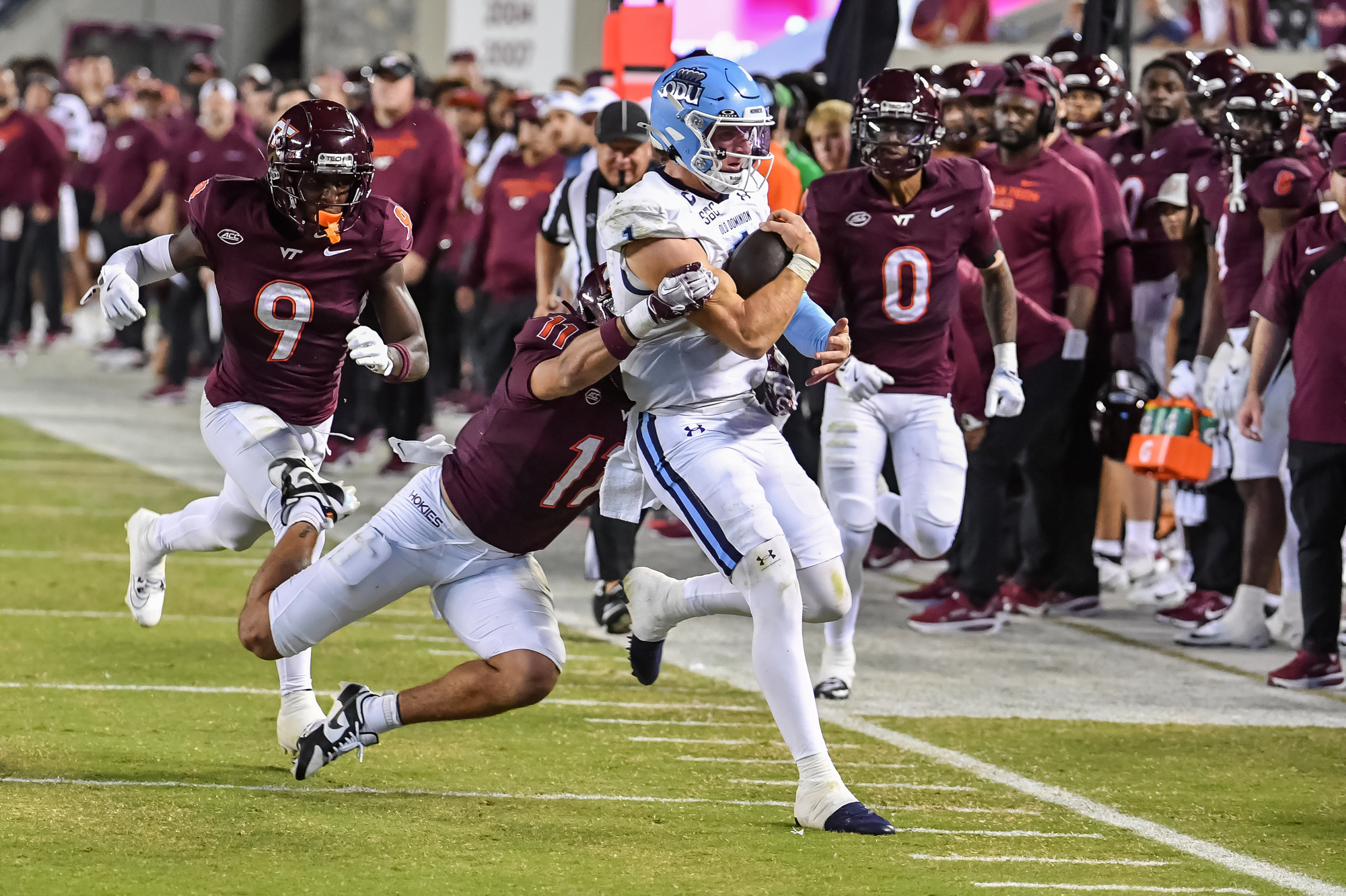 Sep 13, 2025; Blacksburg, Virginia, USA; Virginia Tech Hokies safety Tyson Flowers (11) tackles Old Dominion Monarchs quarterback Colton Joseph (1) during the third quarter at Lane Stadium. Mandatory Credit: Brian Bishop-Imagn Images