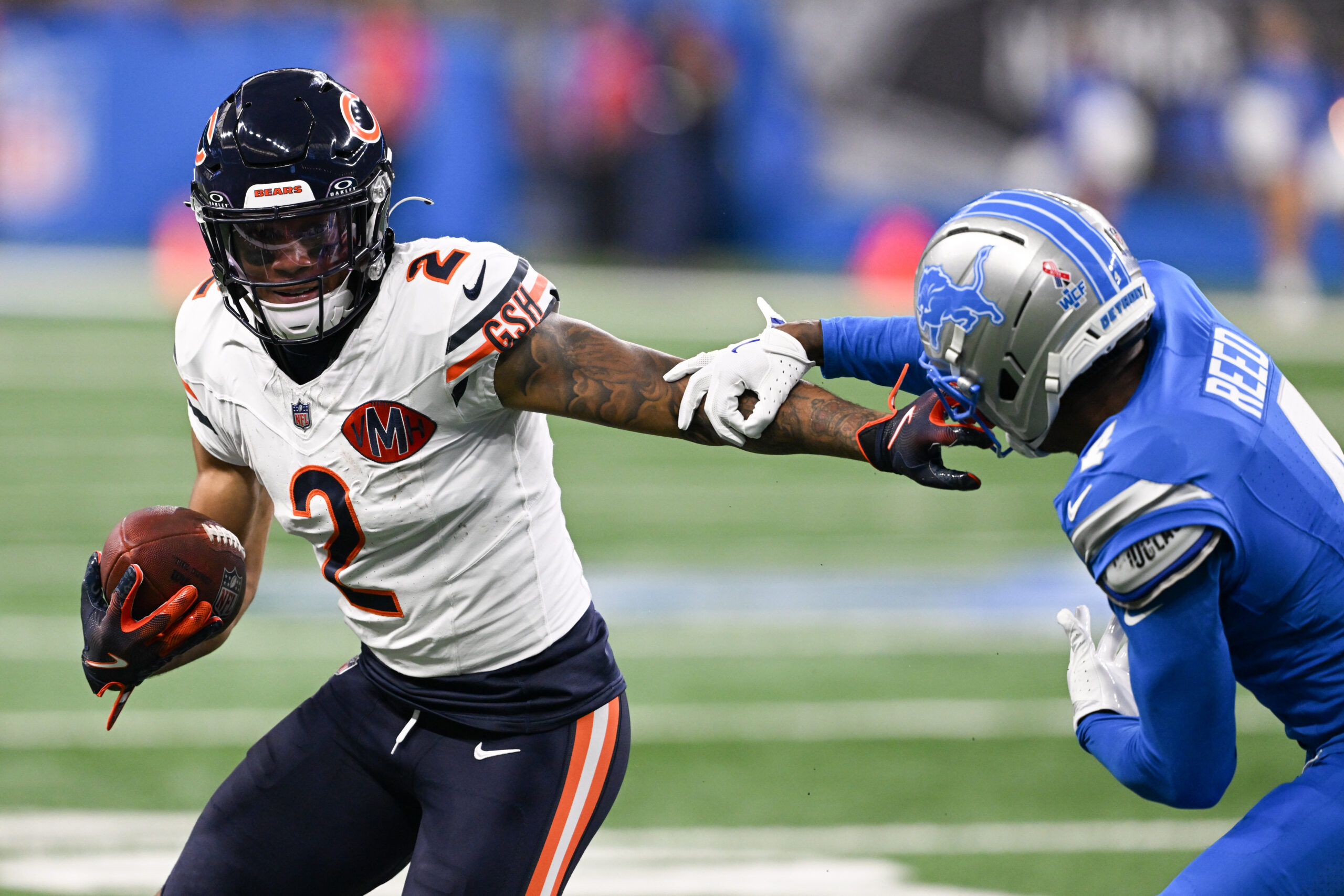 Sep 14, 2025; Detroit, Michigan, USA; Chicago Bears wide receiver DJ Moore (2) carries the ball defended by Detroit Lions cornerback D.J. Reed (4) during the first quarter of the game at Ford Field. Mandatory Credit: Lon Horwedel-Imagn Images