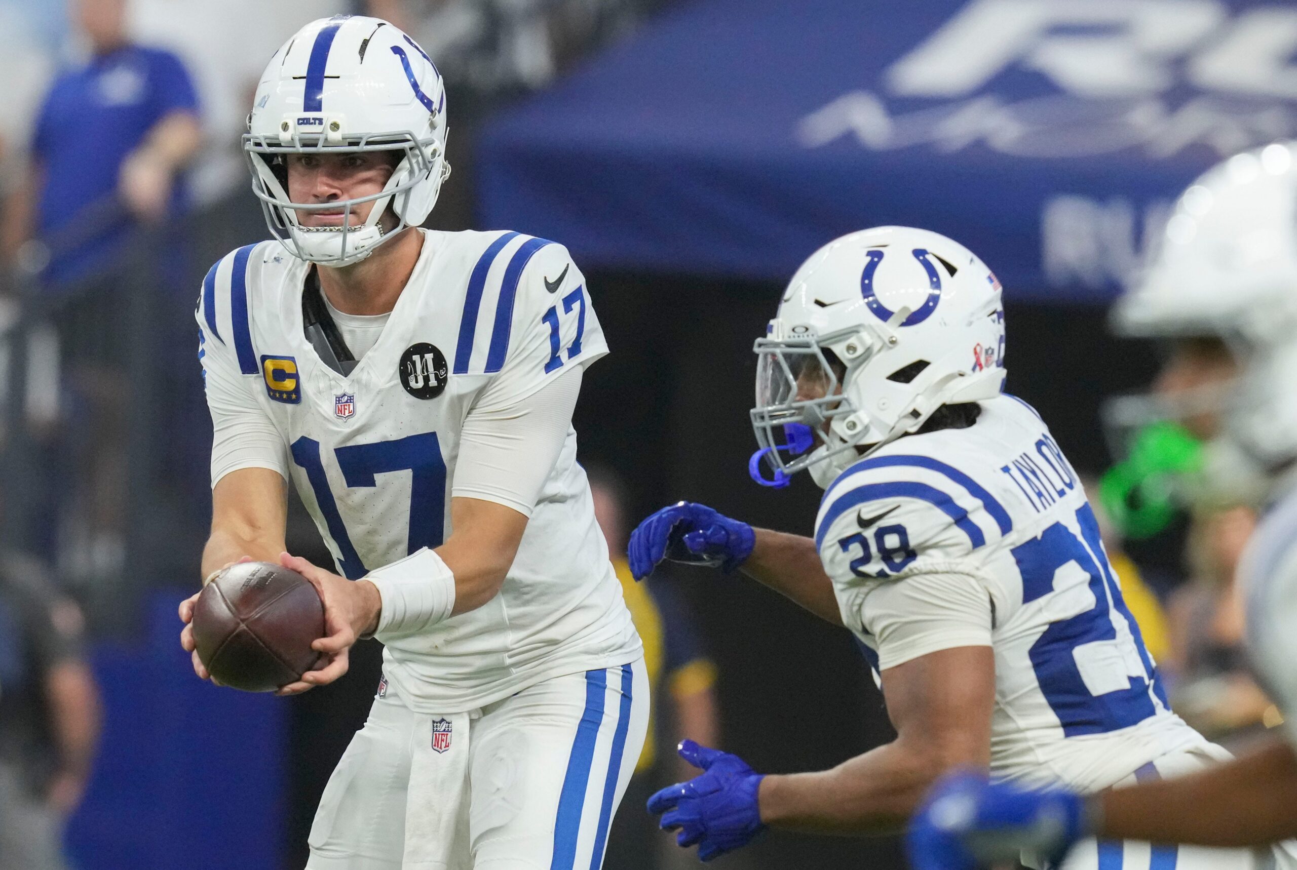 Indianapolis Colts quarterback Daniel Jones (17) hands the ball off to Indianapolis Colts running back Jonathan Taylor (28) on Sunday, Sept. 14, 2025, during a game against the Denver Broncos at Lucas Oil Stadium in Indianapolis.