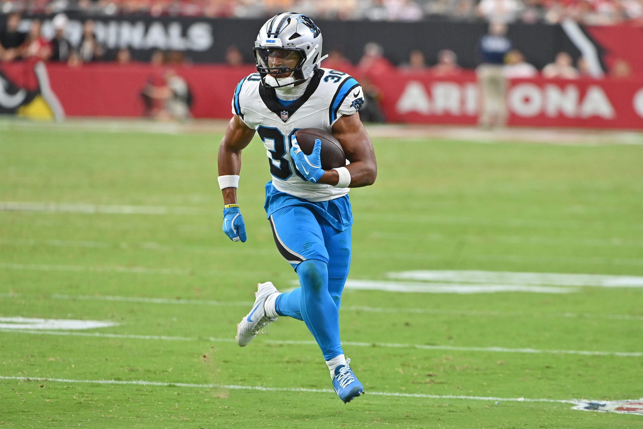 Sep 14, 2025; Glendale, Arizona, USA; Carolina Panthers running back Chuba Hubbard (30) runs with the ball during the fourth quarter against the Arizona Cardinals at State Farm Stadium. Mandatory Credit: Matt Kartozian-Imagn Images