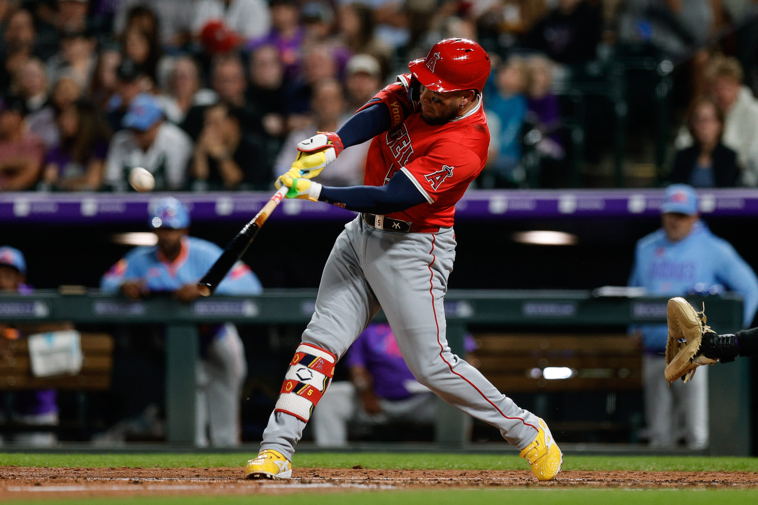 Sep 19, 2025; Denver, Colorado, USA; Los Angeles Angels third baseman Yoan Moncada (5) hits a sacrifice fly RBI in the fifth inning against the Colorado Rockies at Coors Field. Mandatory Credit: Isaiah J. Downing-Imagn Images