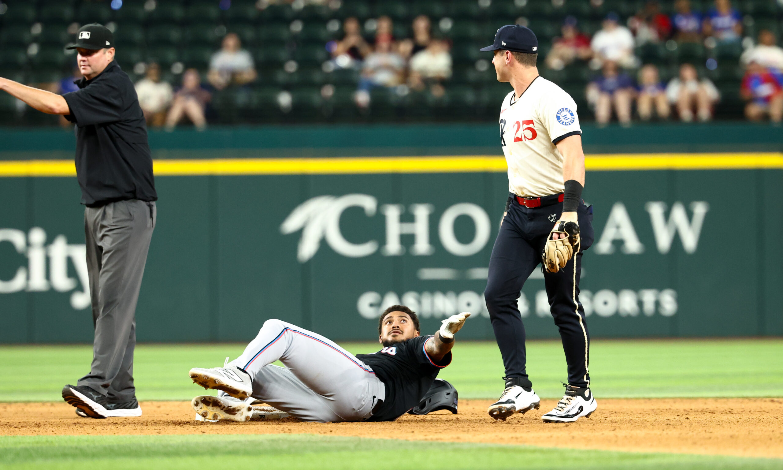 Sep 19, 2025; Arlington, Texas, USA;  Miami Marlins center fielder Dane Myers (54) stares at Texas Rangers second baseman Dylan Moore (25) at second base during the twelfth inning at Globe Life Field. Mandatory Credit: Kevin Jairaj-Imagn Images