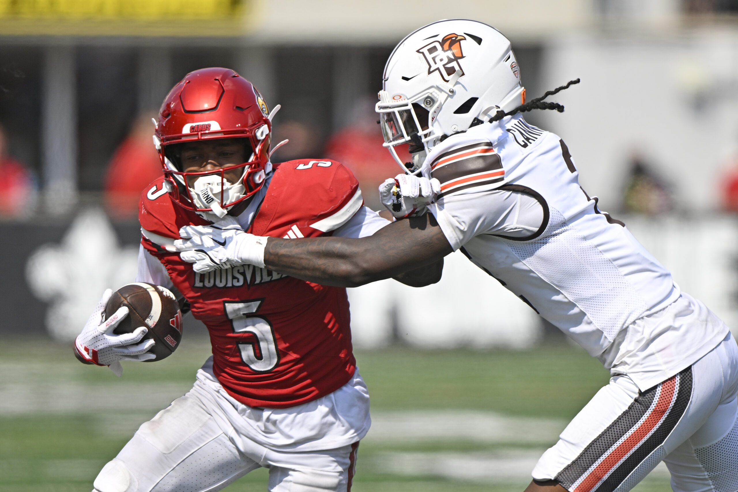Sep 20, 2025; Louisville, Kentucky, USA; Louisville Cardinals wide receiver Caullin Lacy (5) is defended by Bowling Green Falcons cornerback MJ Cannon (2) during the second half at L&N Federal Credit Union Stadium. Louisville defeated Bowling Green 40-17. Mandatory Credit: Jamie Rhodes-Imagn Images