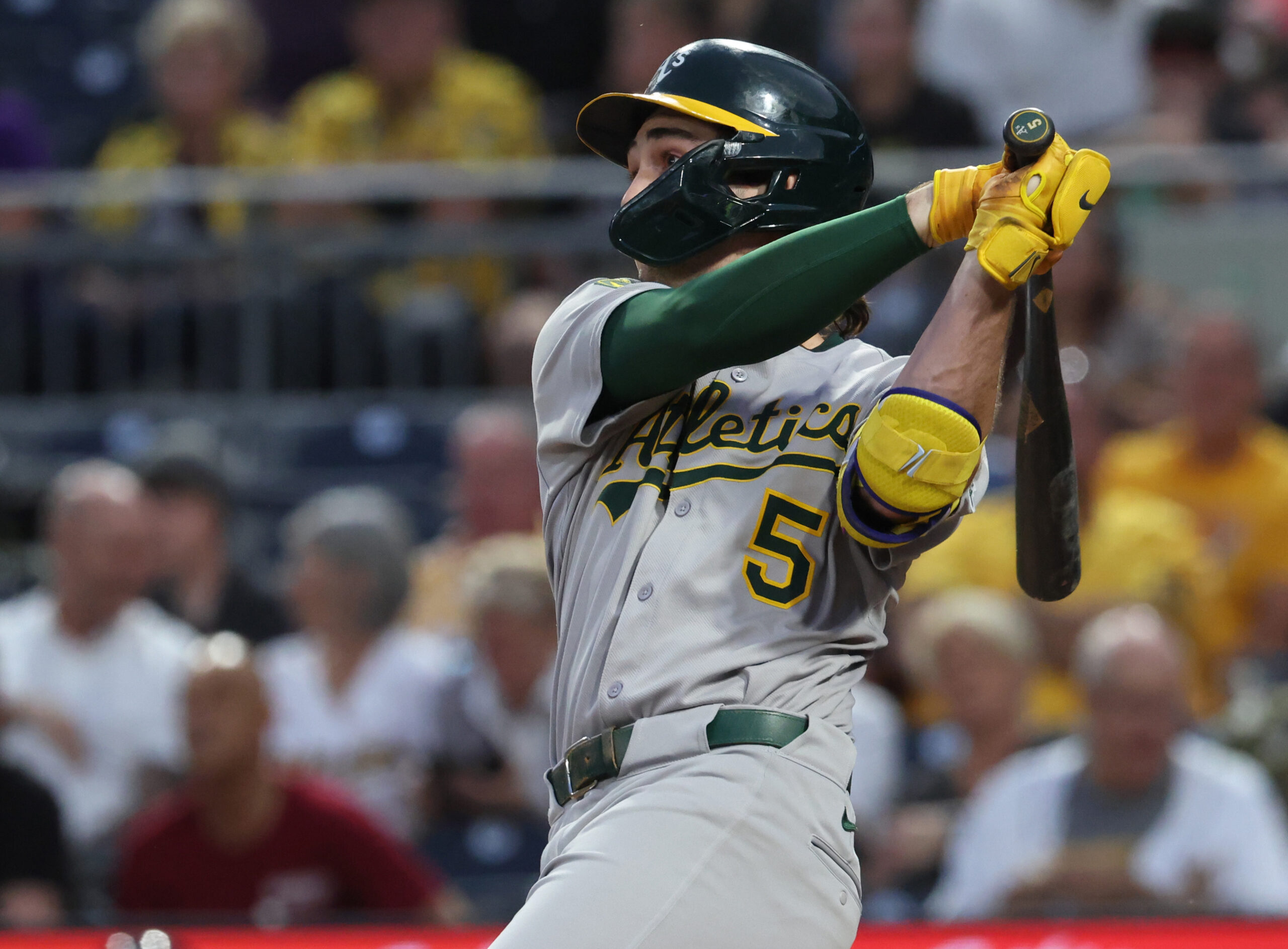 Sep 20, 2025; Pittsburgh, Pennsylvania, USA; Athletics shortstop Jacob Wilson (5) hits a double against the Pittsburgh Pirates during the second inning at PNC Park. Mandatory Credit: Charles LeClaire-Imagn Images