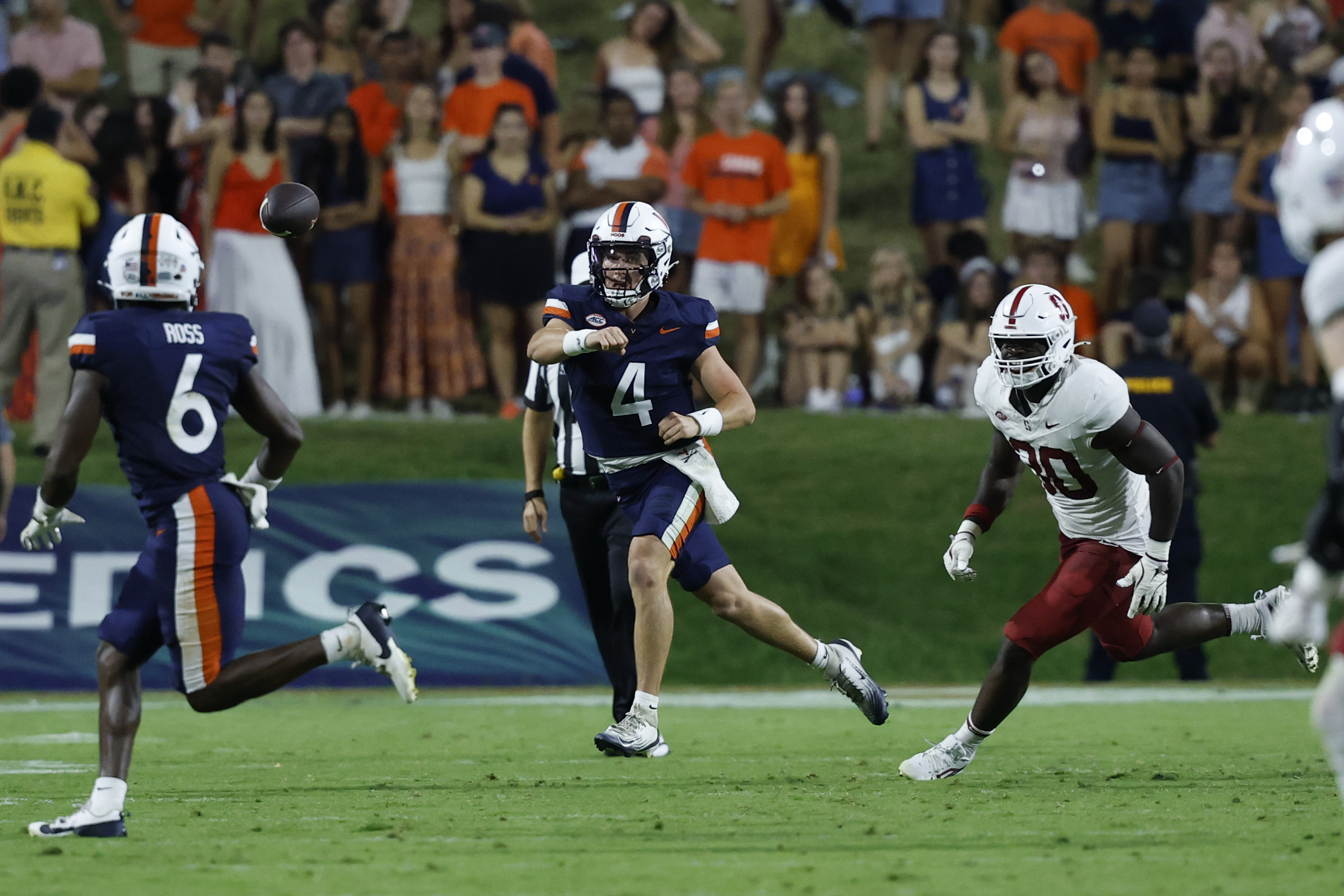 Sep 20, 2025; Charlottesville, Virginia, USA; Virginia Cavaliers quarterback Chandler Morris (4) passes the ball to Cavaliers wide receiver Cam Ross (6) as Stanford Cardinal linebacker Ese Dubre (30) chases during the second quarter at Scott Stadium. Mandatory Credit: Geoff Burke-Imagn Images