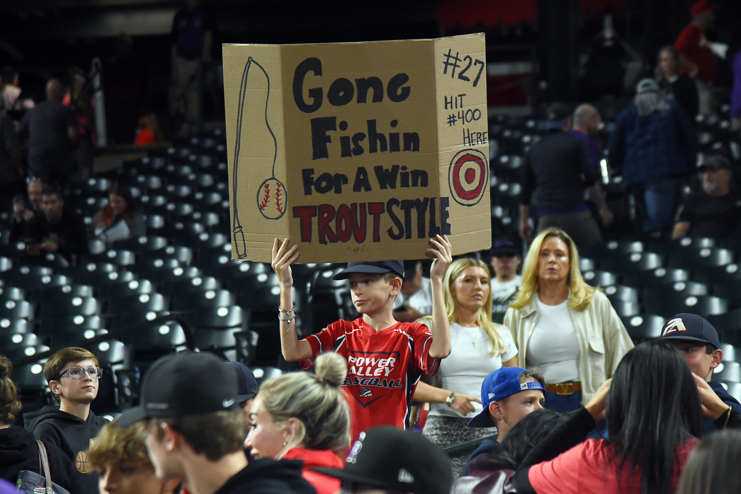 Sep 20, 2025; Denver, Colorado, USA; A young fan holds a sign after a win by the Los Angeles Angels over the Colorado Rockies at Coors Field. Mandatory Credit: Christopher Hanewinckel-Imagn Images